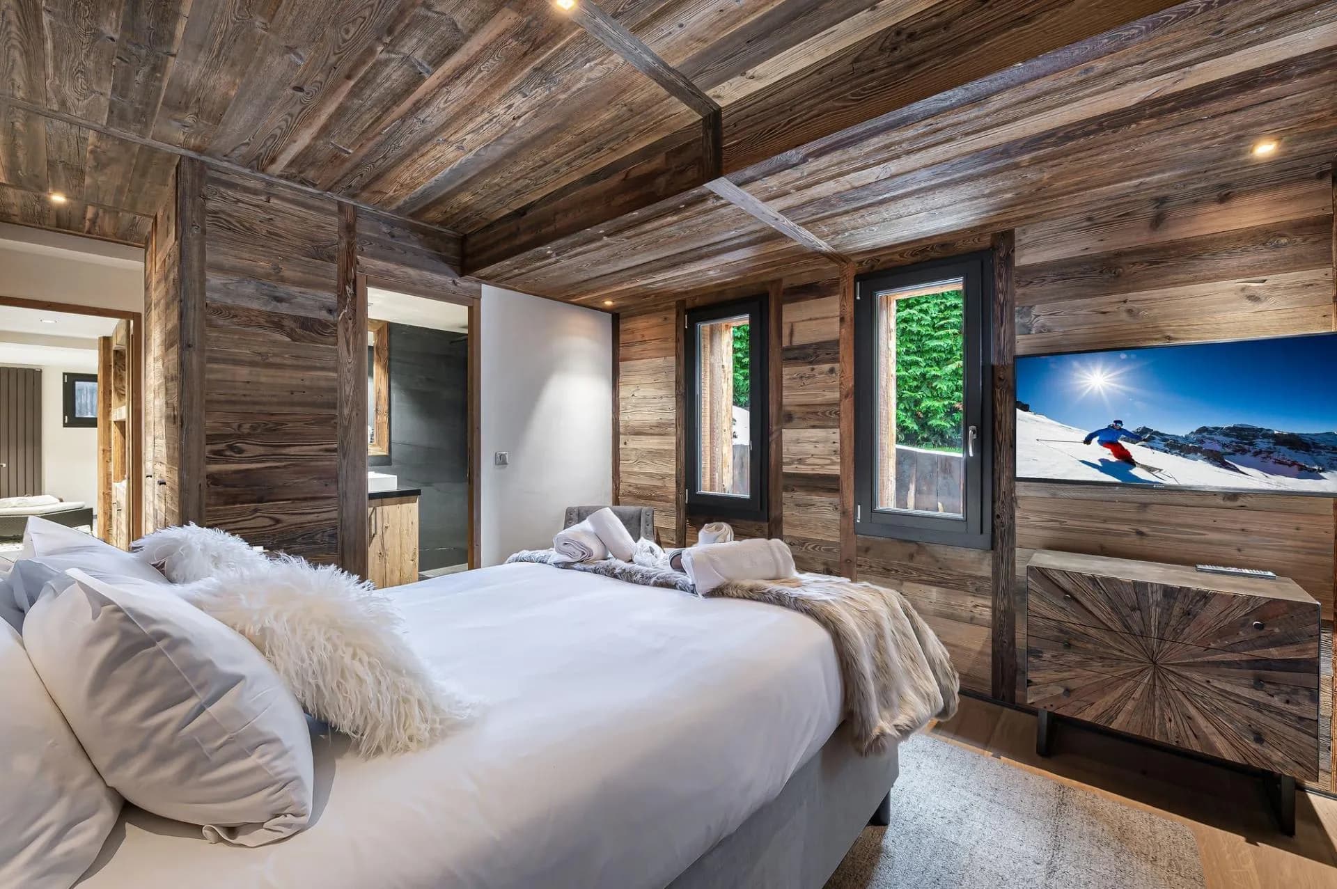 Double bedroom with timber walls and en-suite access