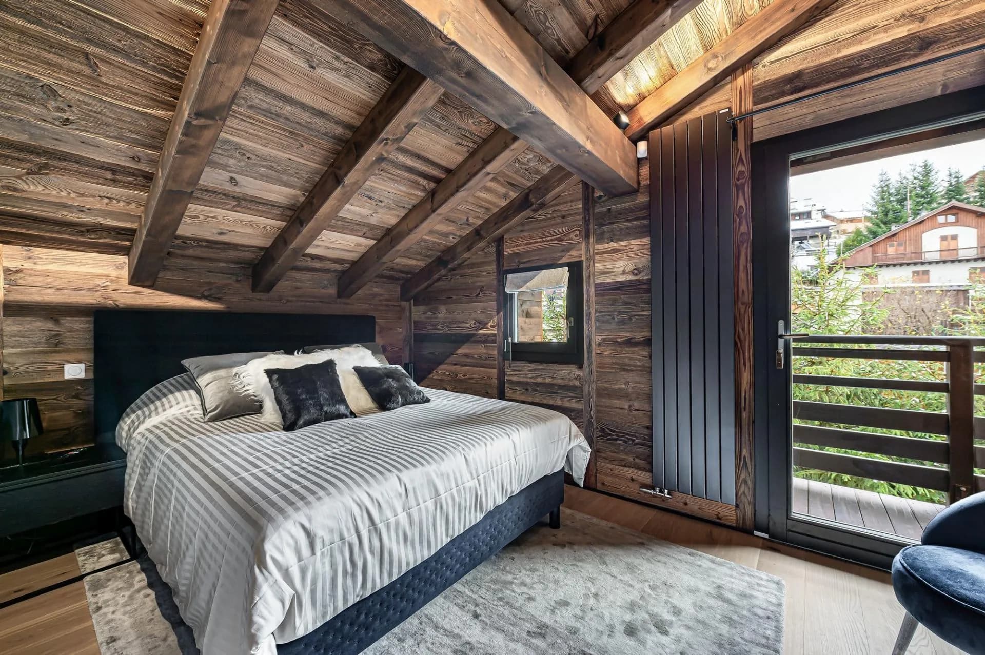 Double bedroom with exposed beams and balcony access
