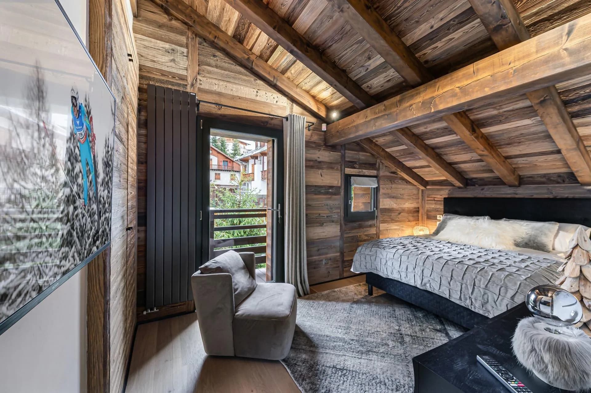 Double bedroom with timber walls and direct balcony access