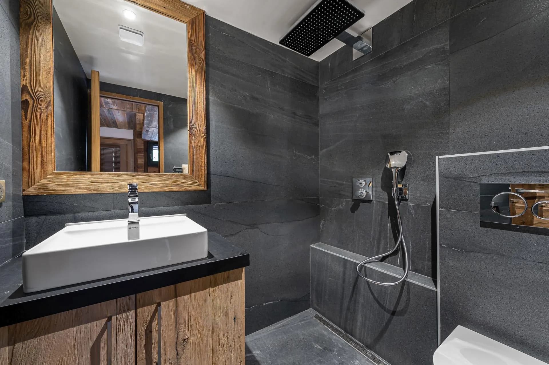 En-suite shower room with slate tiling and heated towel rail