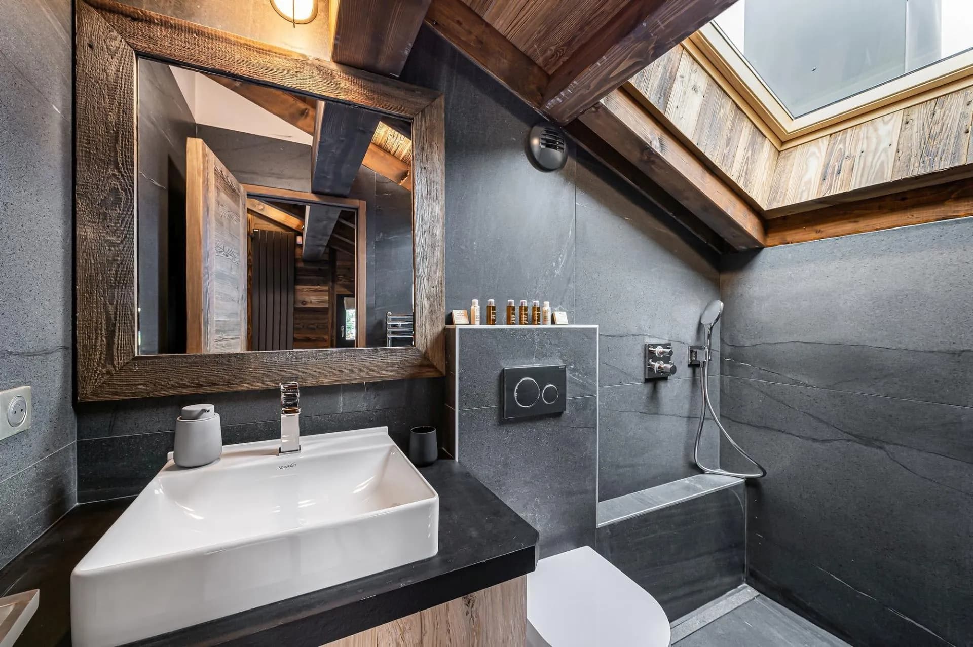 En-suite shower room with skylight and natural stone finishes