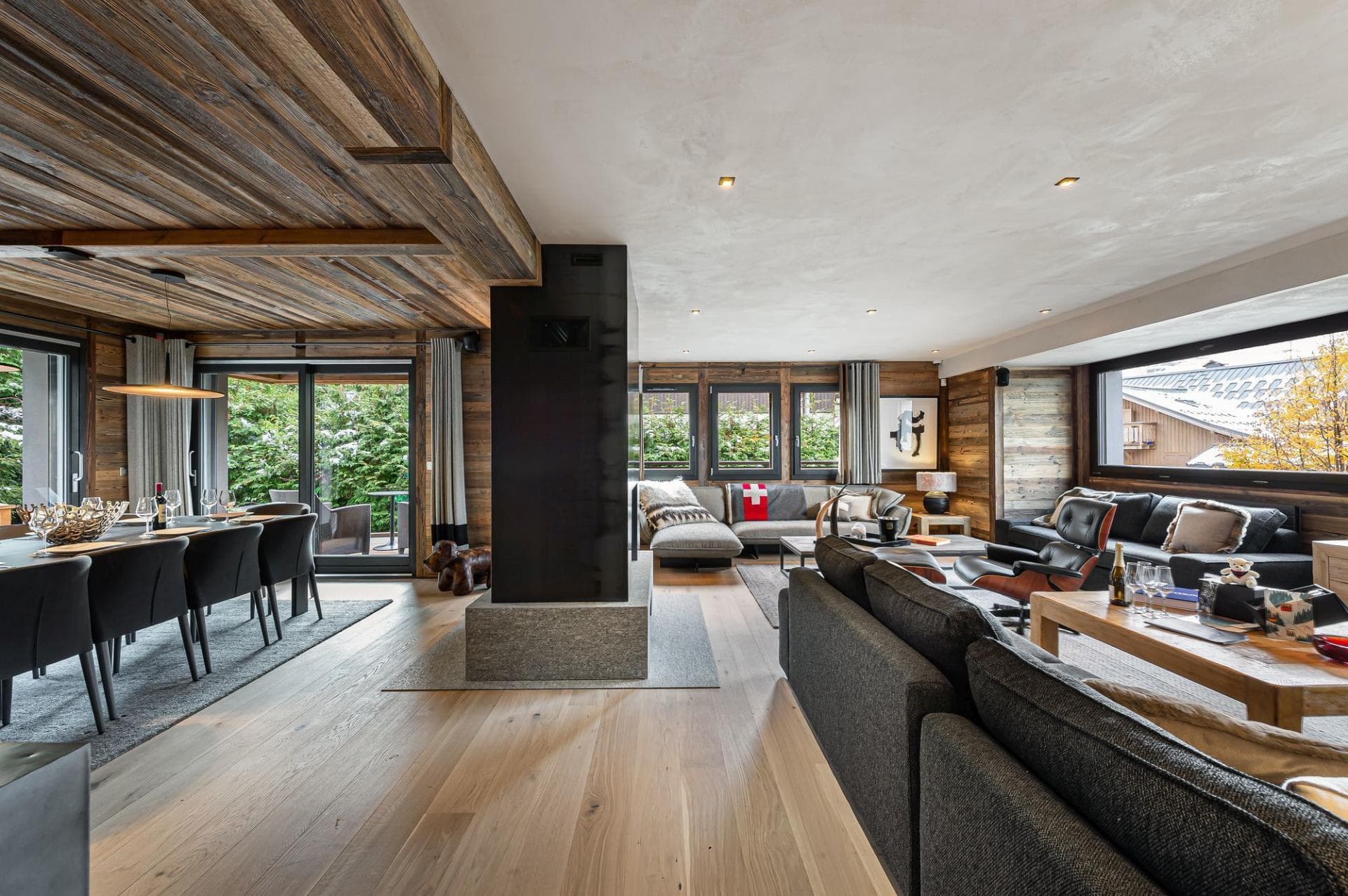 Open-plan living area with central double-sided fireplace and terrace access