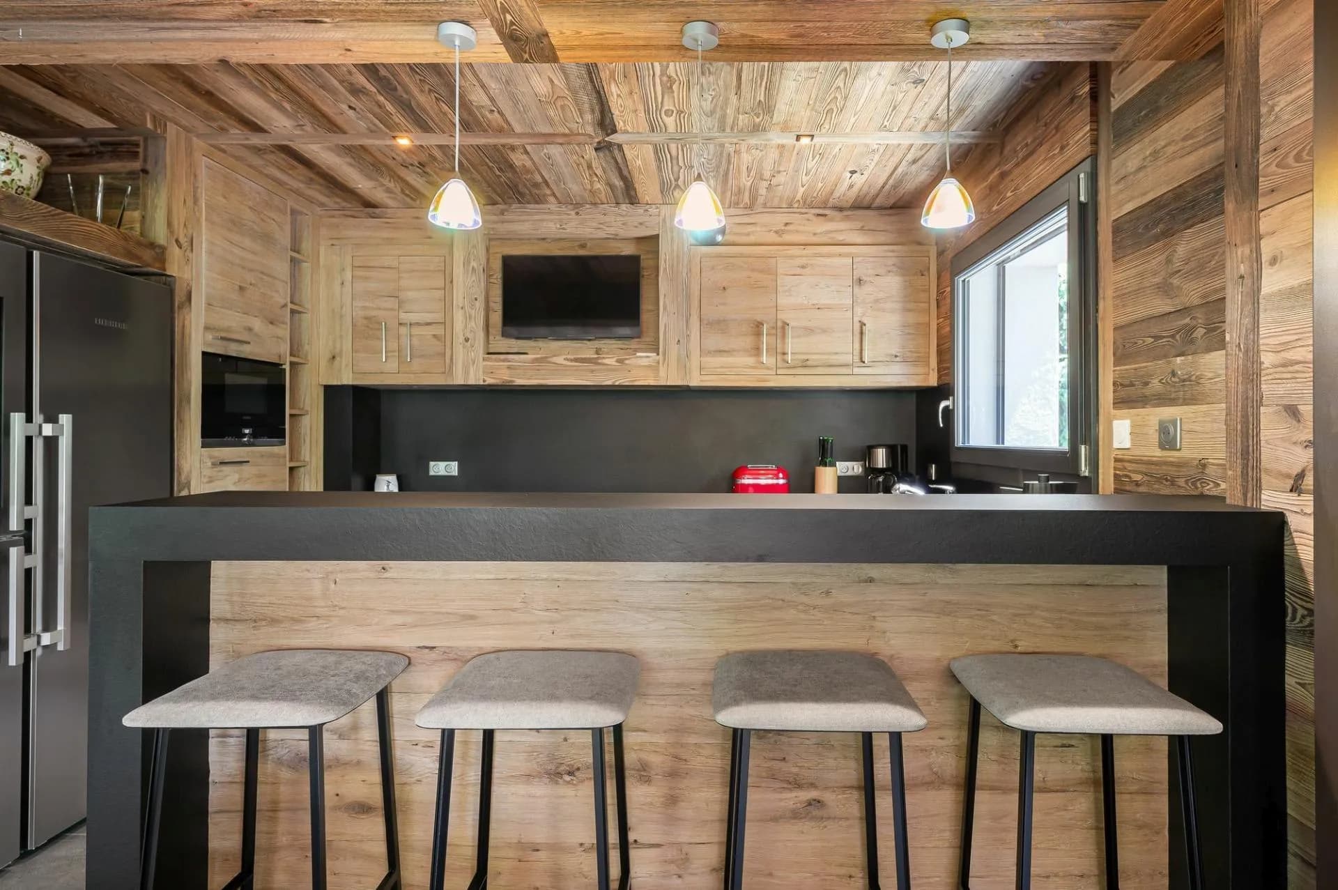 Open kitchen with breakfast bar and integrated appliances
