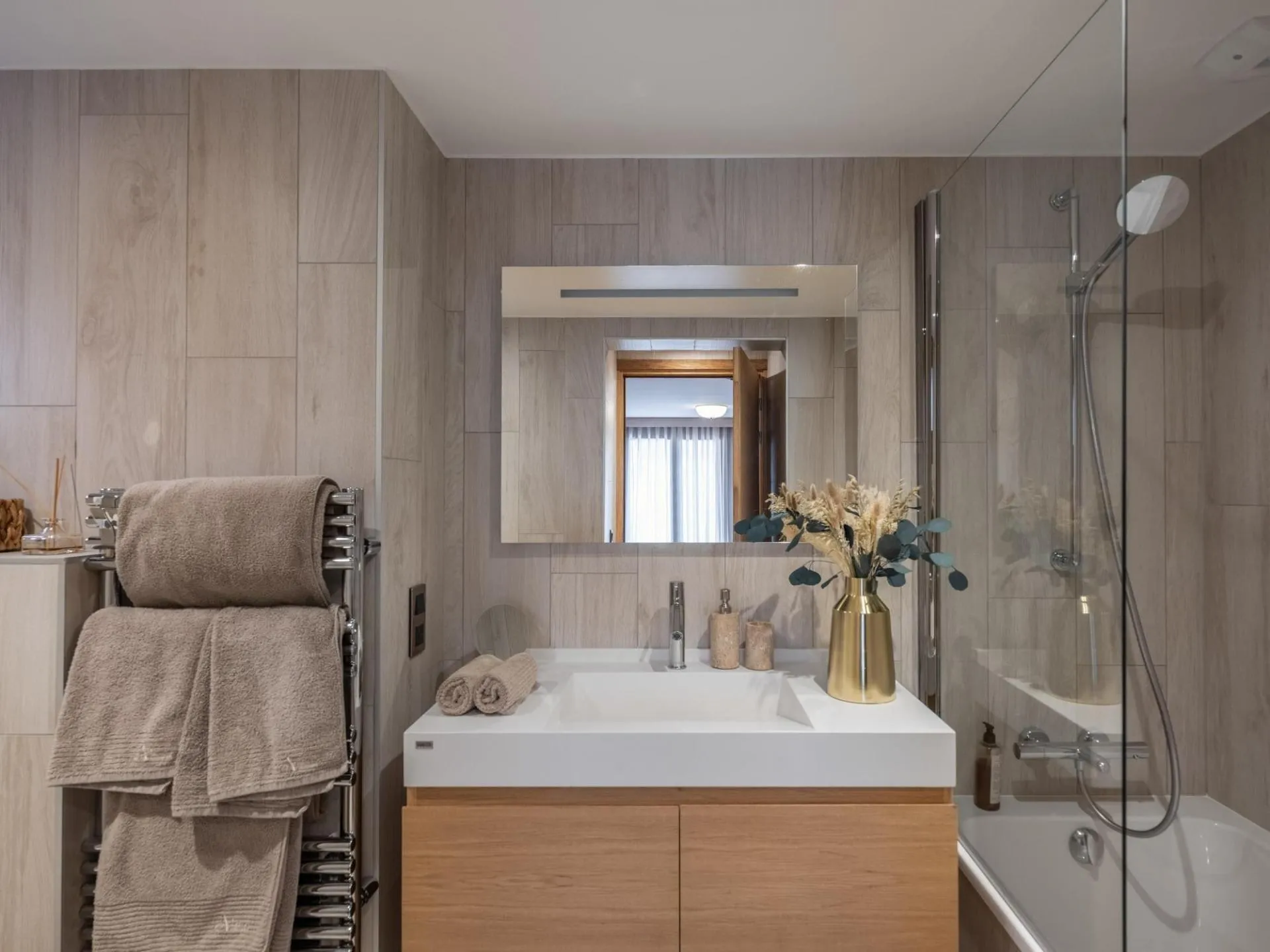 Bathroom with vanity and heated towel rail