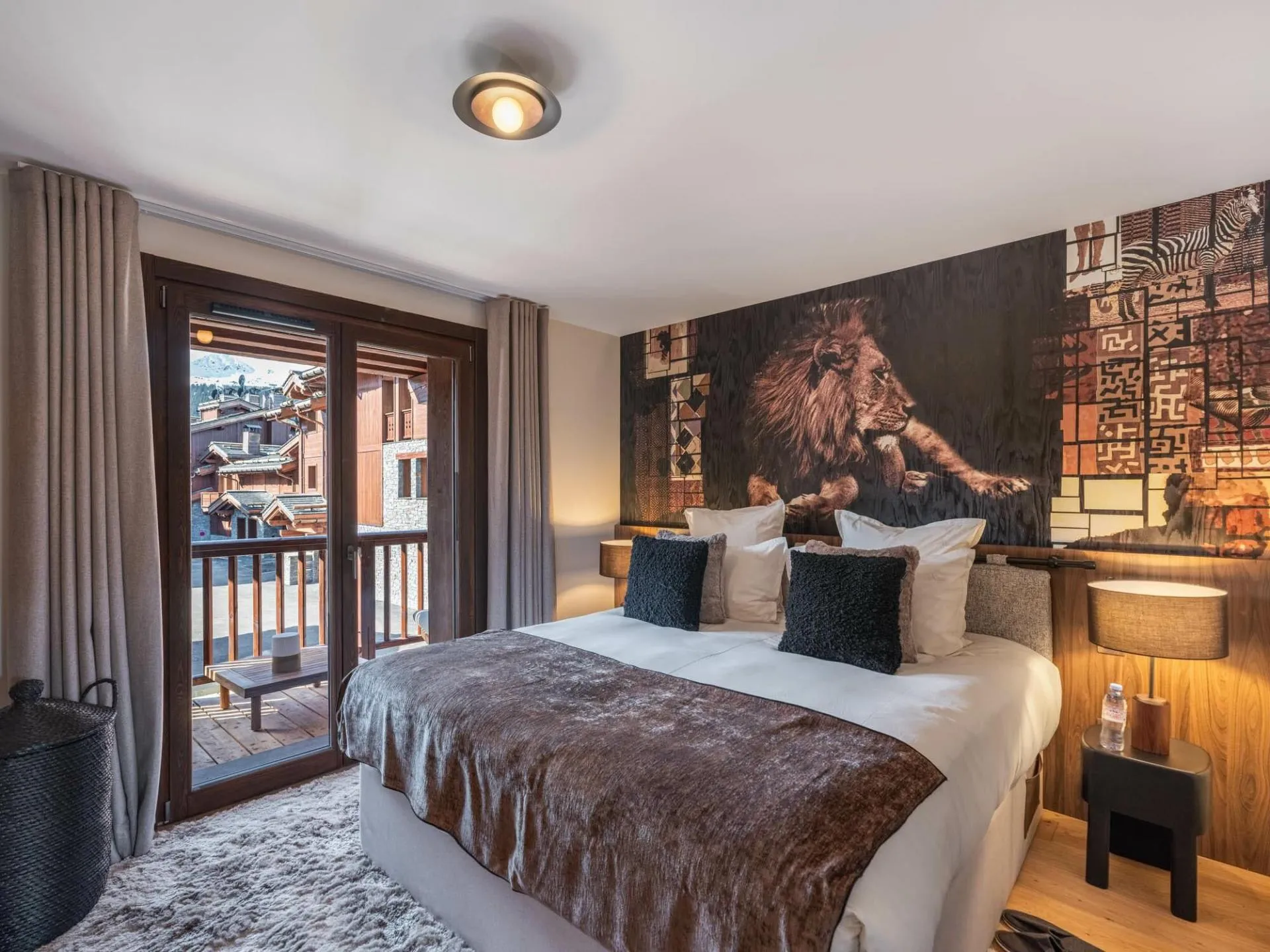 Double bedroom with lion mural and balcony doors