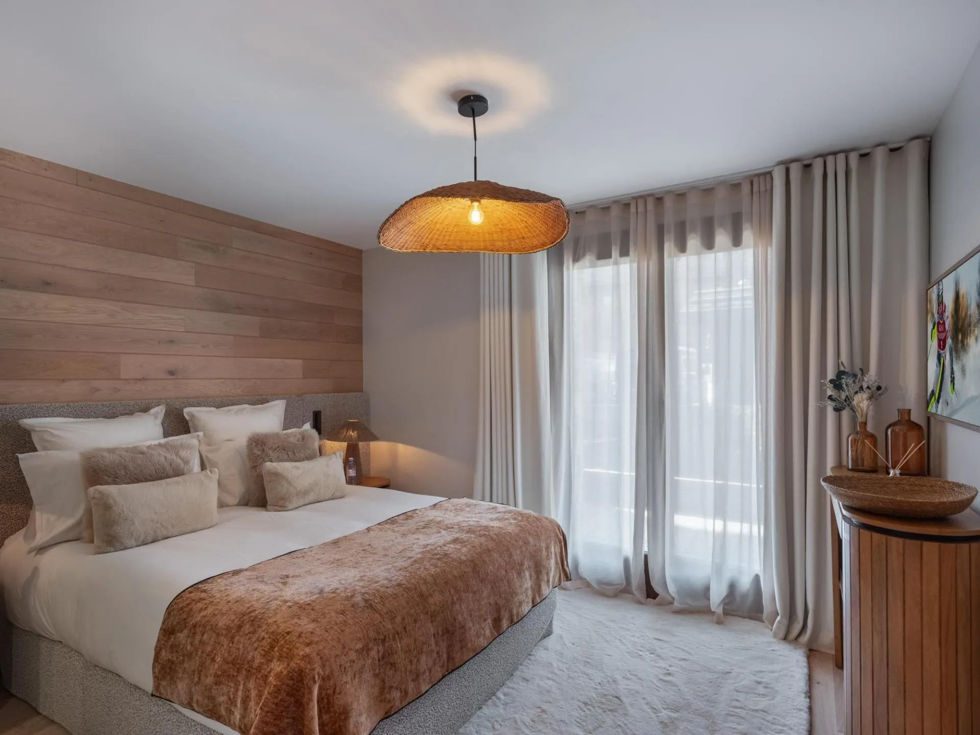 Double bedroom with timber wall and glazed doors