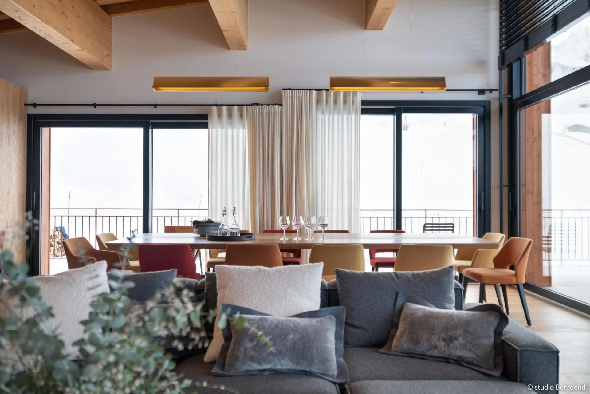 Open-plan living and dining area with balcony access
