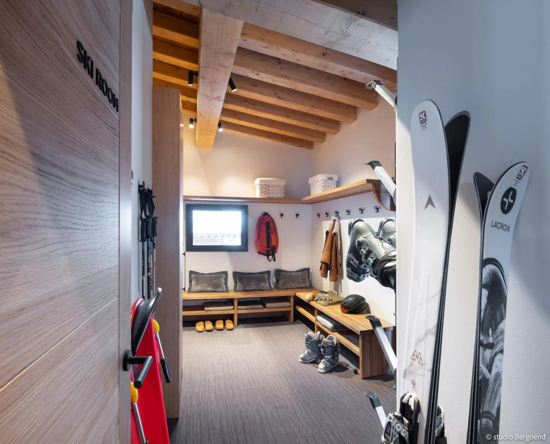 Ski room with heated boot racks, bench and equipment storage