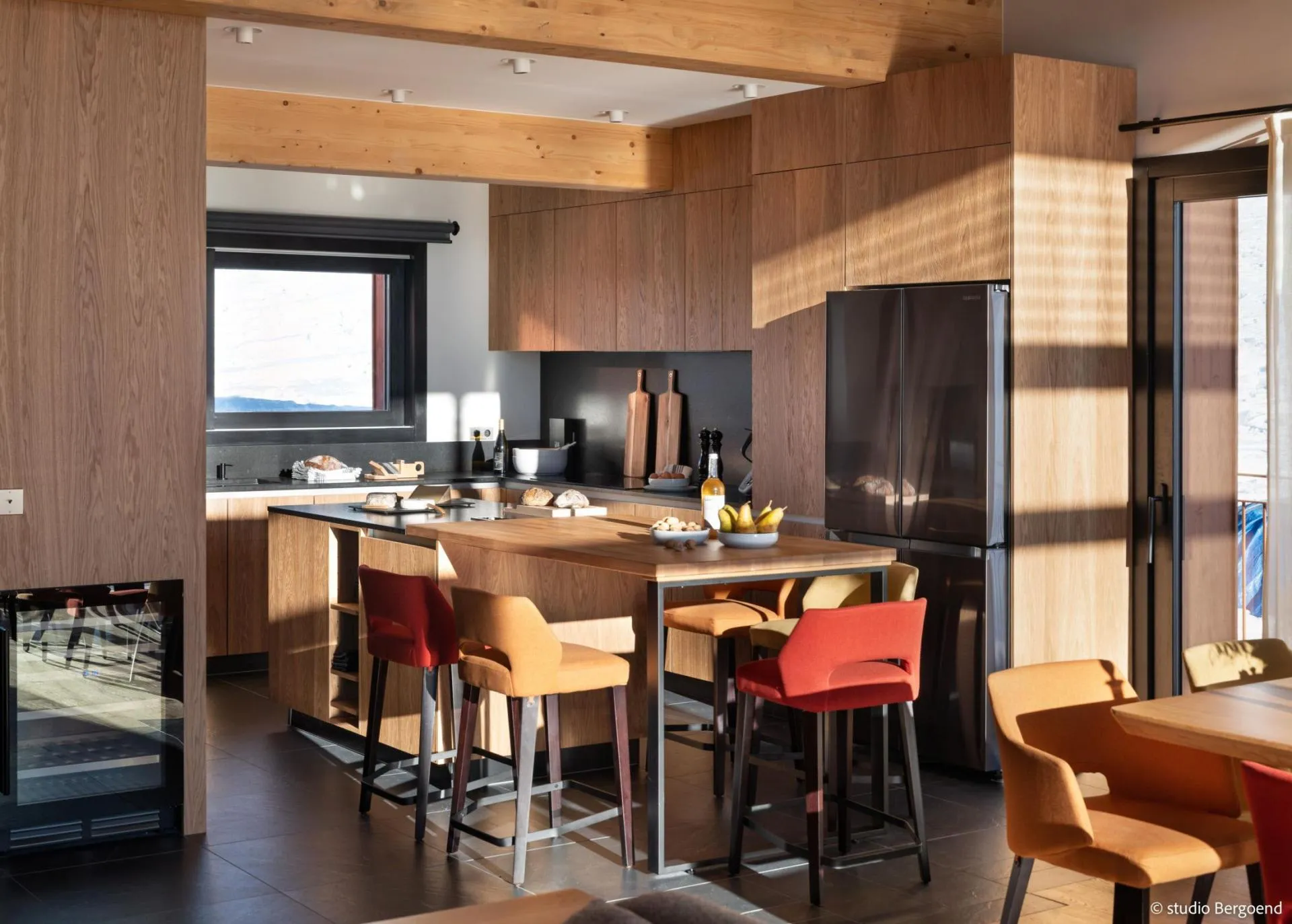 Open kitchen with island seating and integrated wine cooler
