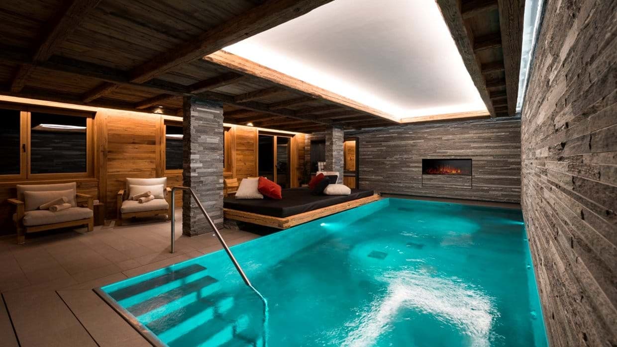 Indoor heated pool with integrated daybed and electric fireplace