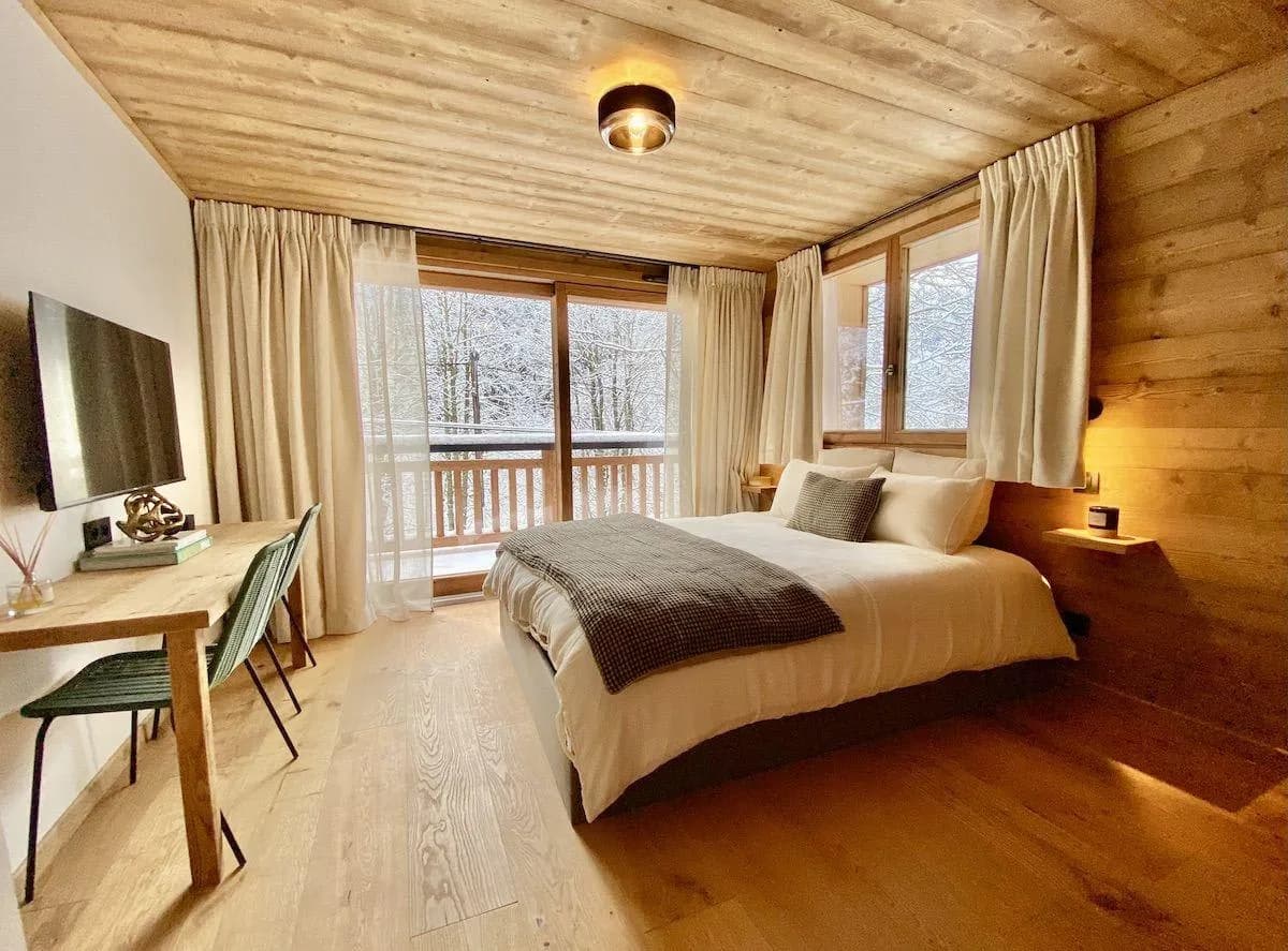 Guest bedroom with dedicated workspace and private balcony access