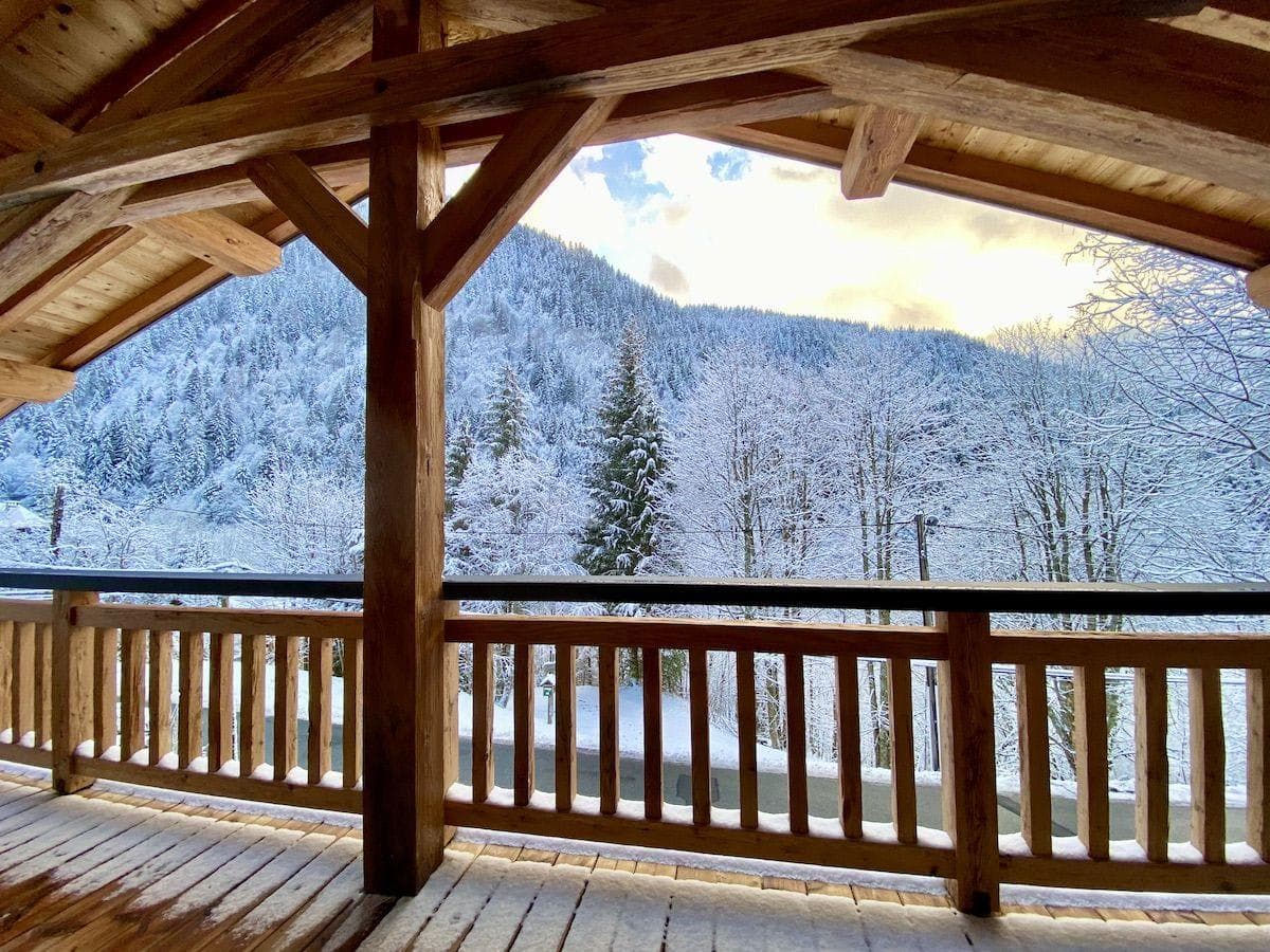 Covered timber balcony with forest and mountain views