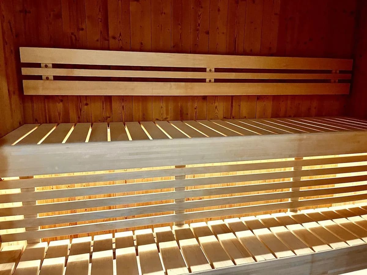 Private cedar sauna with tiered seating and integrated LED backlighting