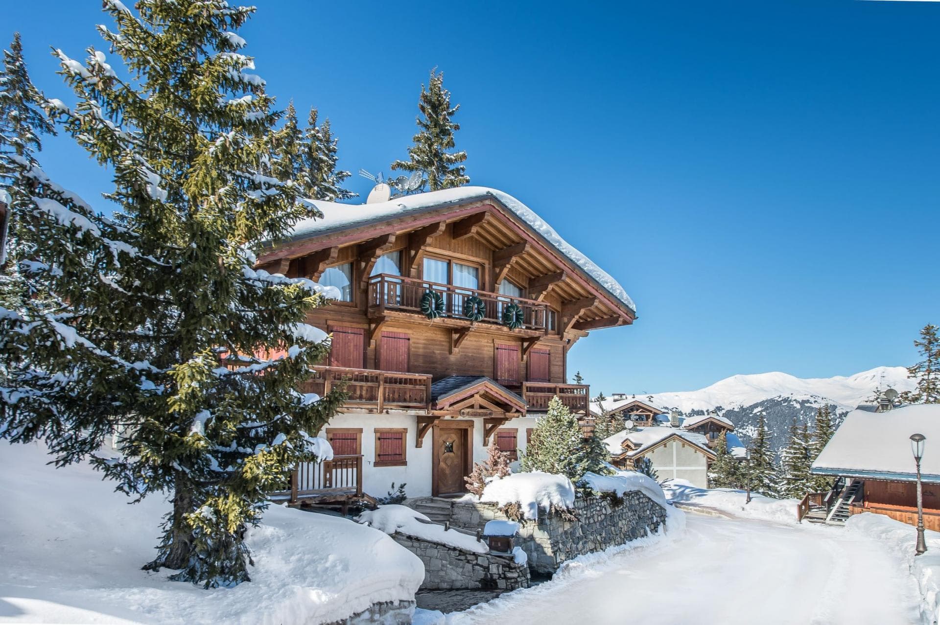 Three-story chalet with wooden balconies and mountain views