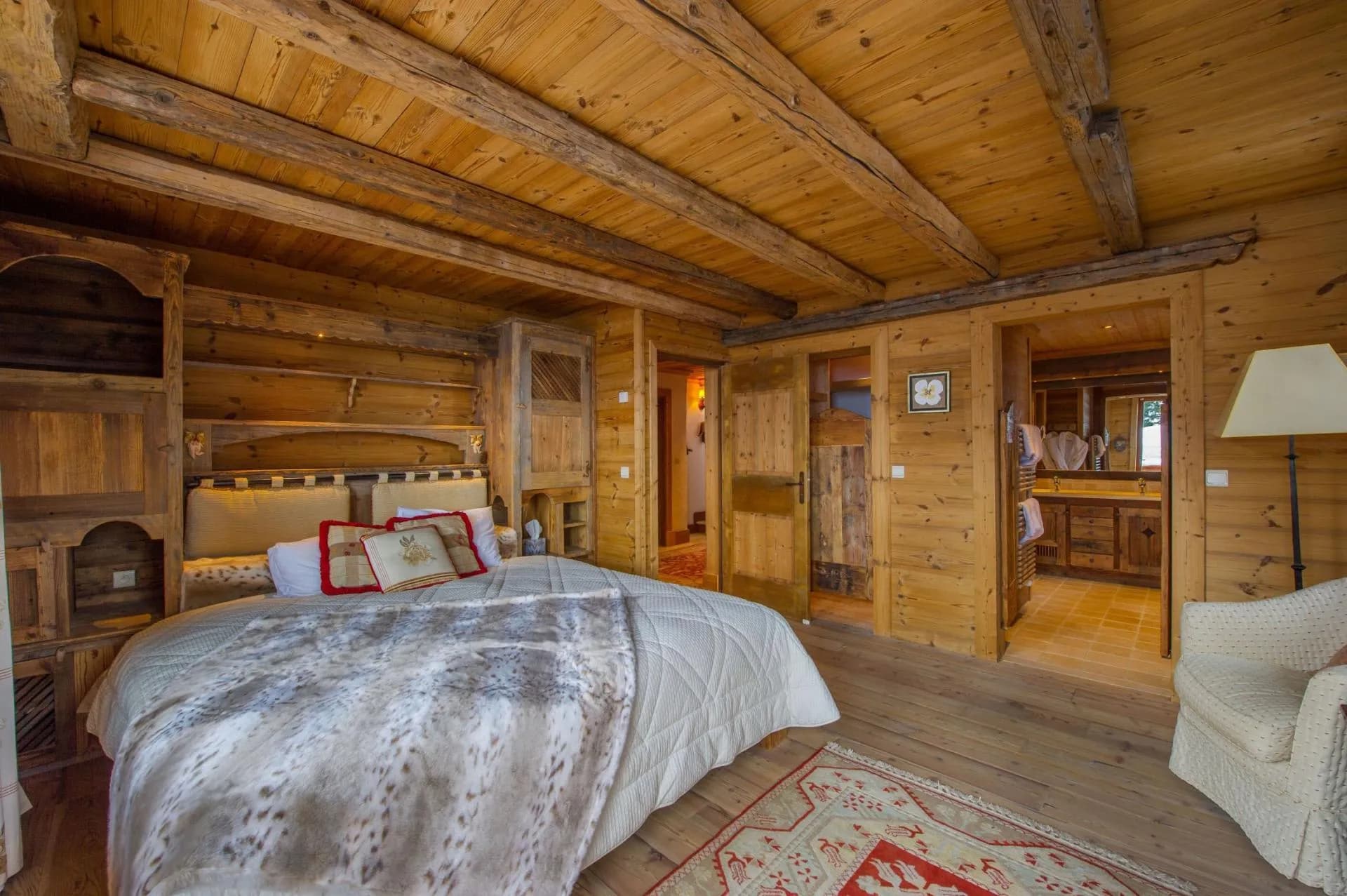 Double bedroom with timber panelling and adjoining bathroom