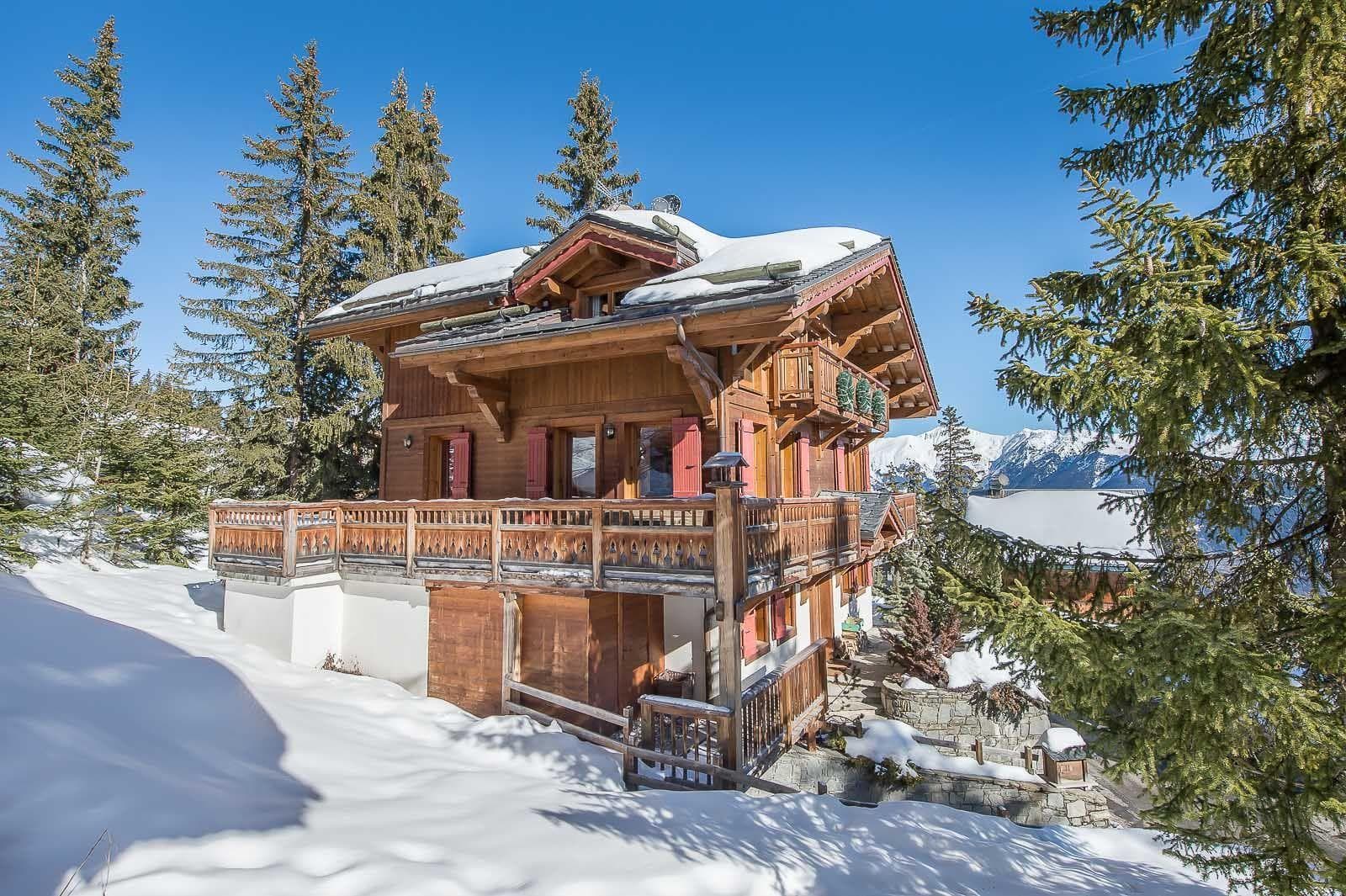 timber chalet with tiered balconies and panoramic mountain views
