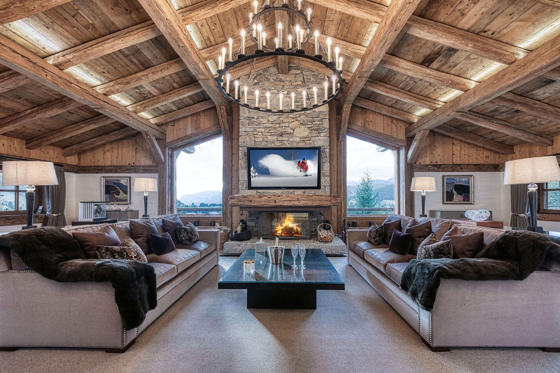 Living area with wood-burning fireplace and vaulted timber ceilings