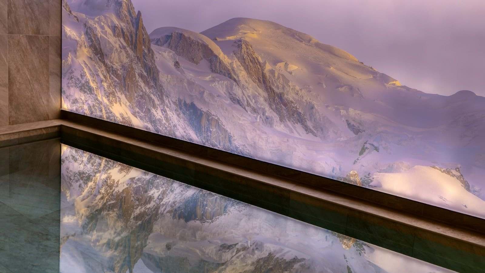 Indoor infinity pool with panoramic Alpine views