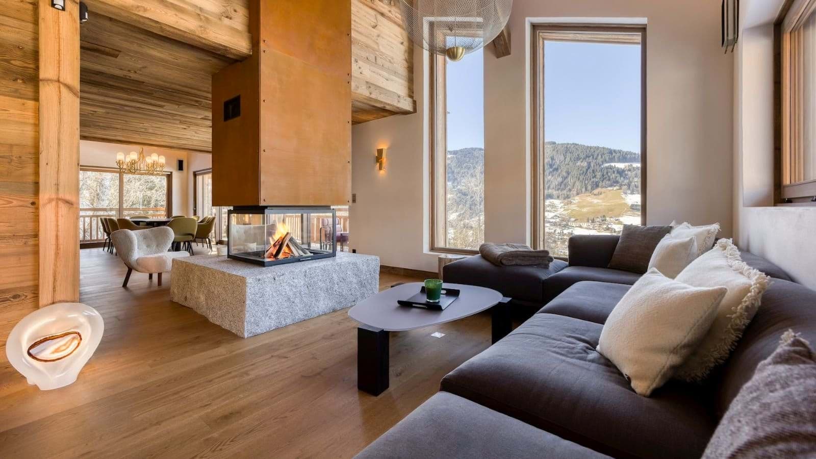 Living area with 360-degree fireplace and valley views