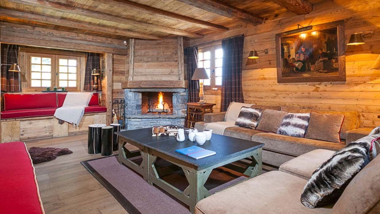 Living area with wood-burning stone fireplace and integrated window seating