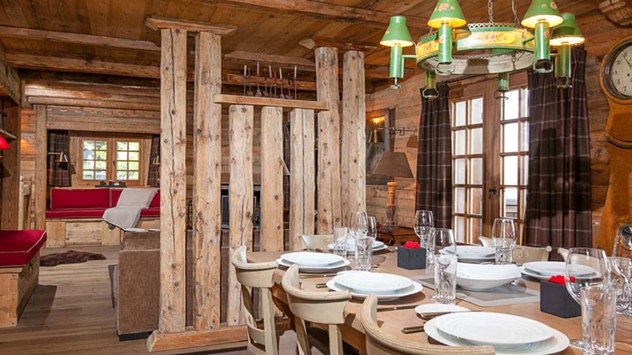 Dining area with timber partition; living room and fireplace beyond