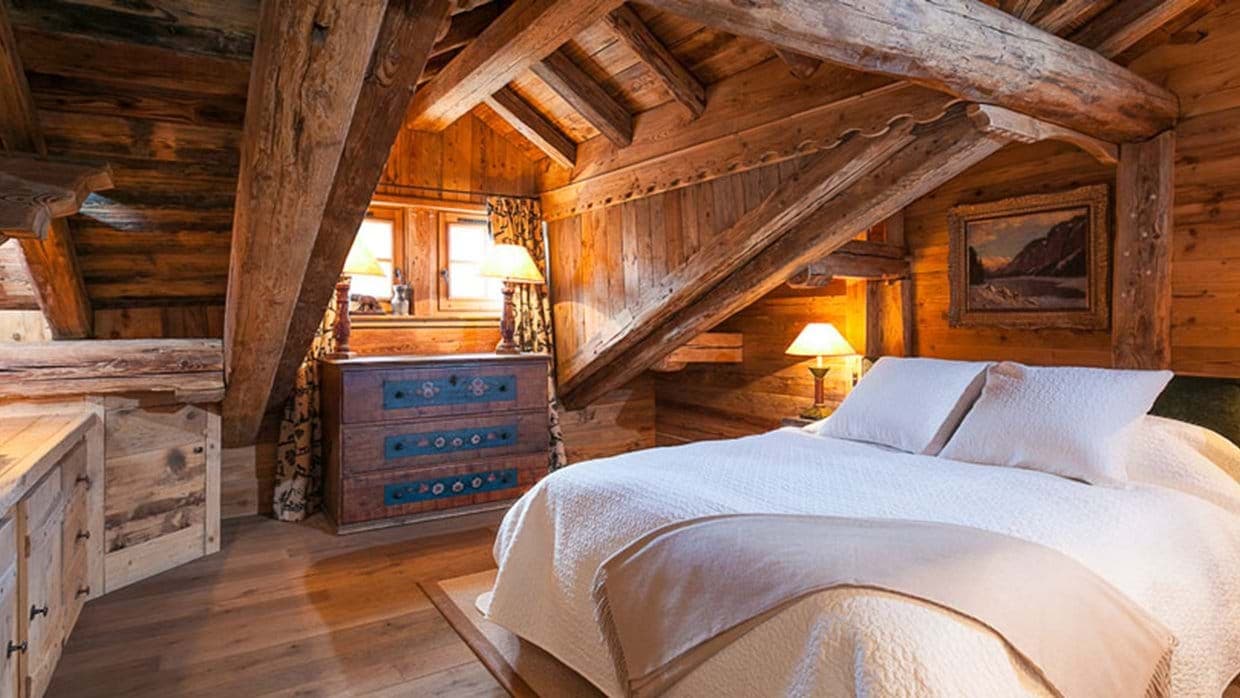 Attic bedroom with queen bed and original exposed timber beams