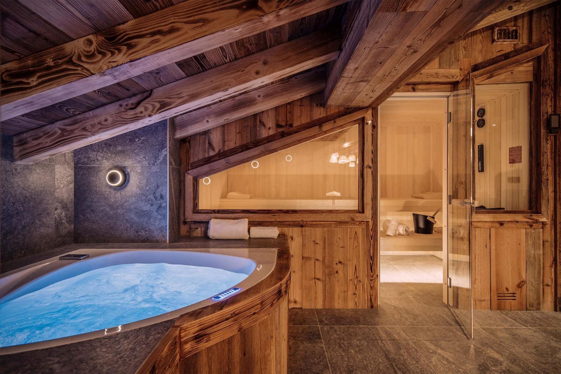 Spa area with jetted tub and adjacent wood-lined sauna