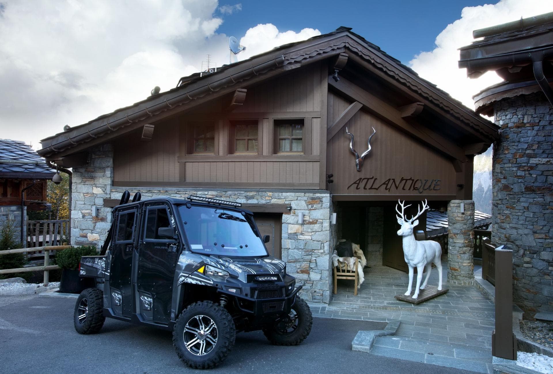 Chalet entrance with 4-seater Polaris for guest transport