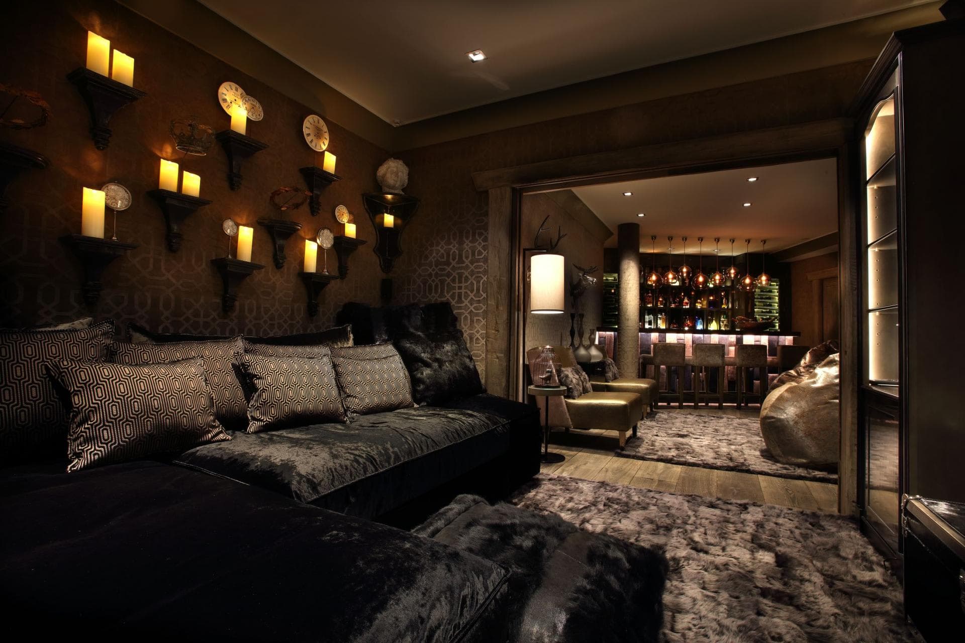 Media lounge with oversized velvet sectional and private 4-seat bar