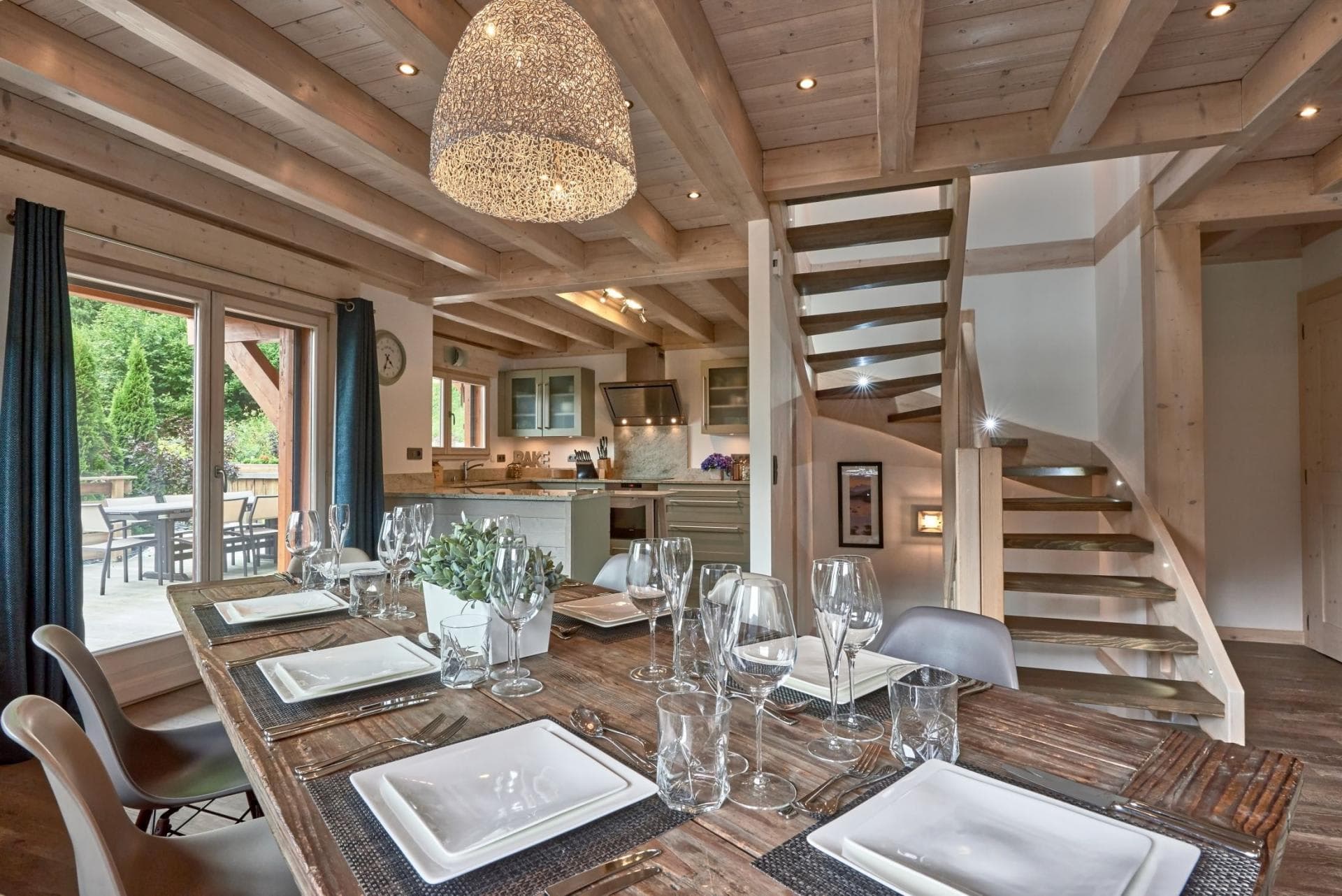 Open-plan dining area and kitchen with terrace access and staircase
