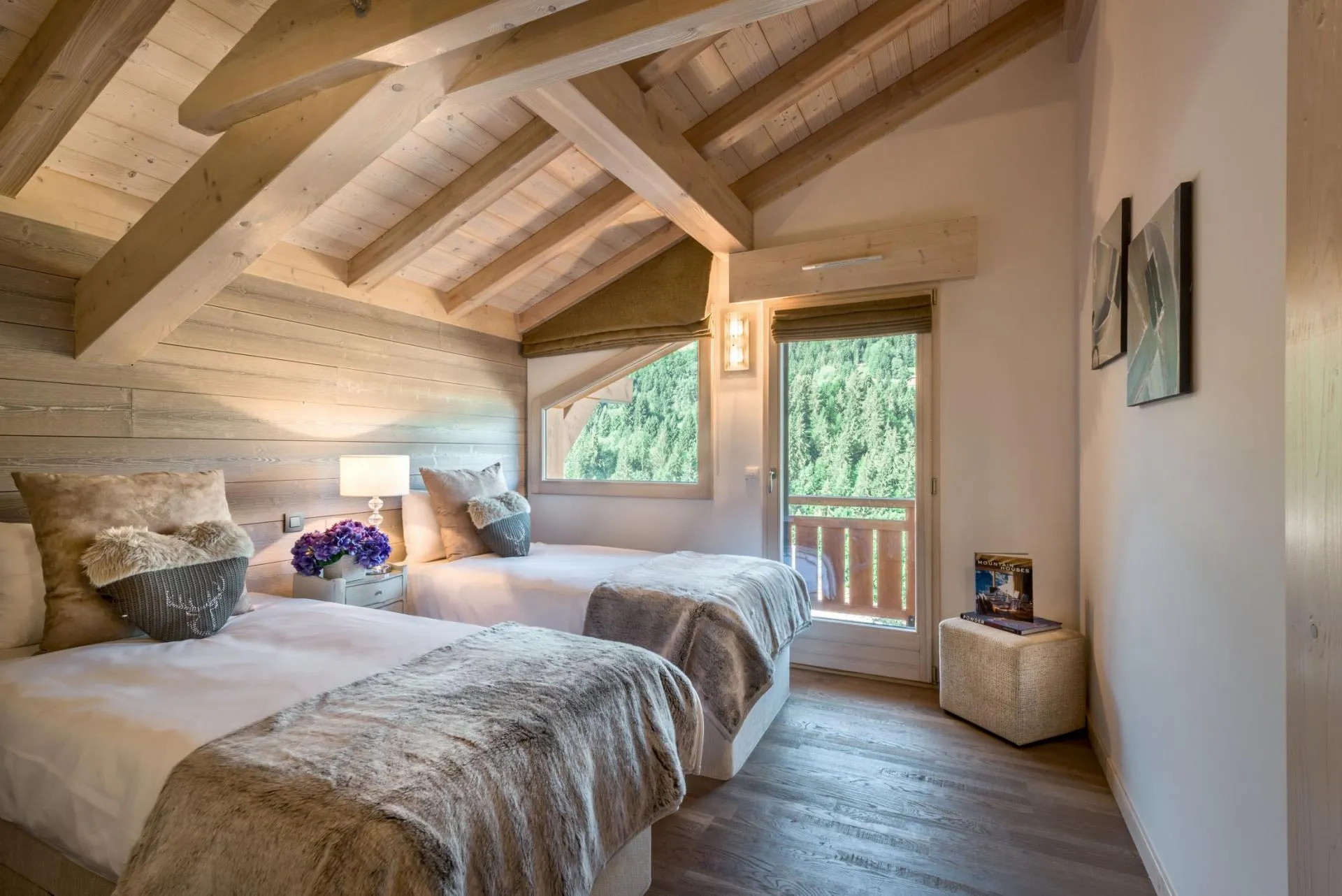 Guest bedroom with twin beds, timber ceilings, and balcony access