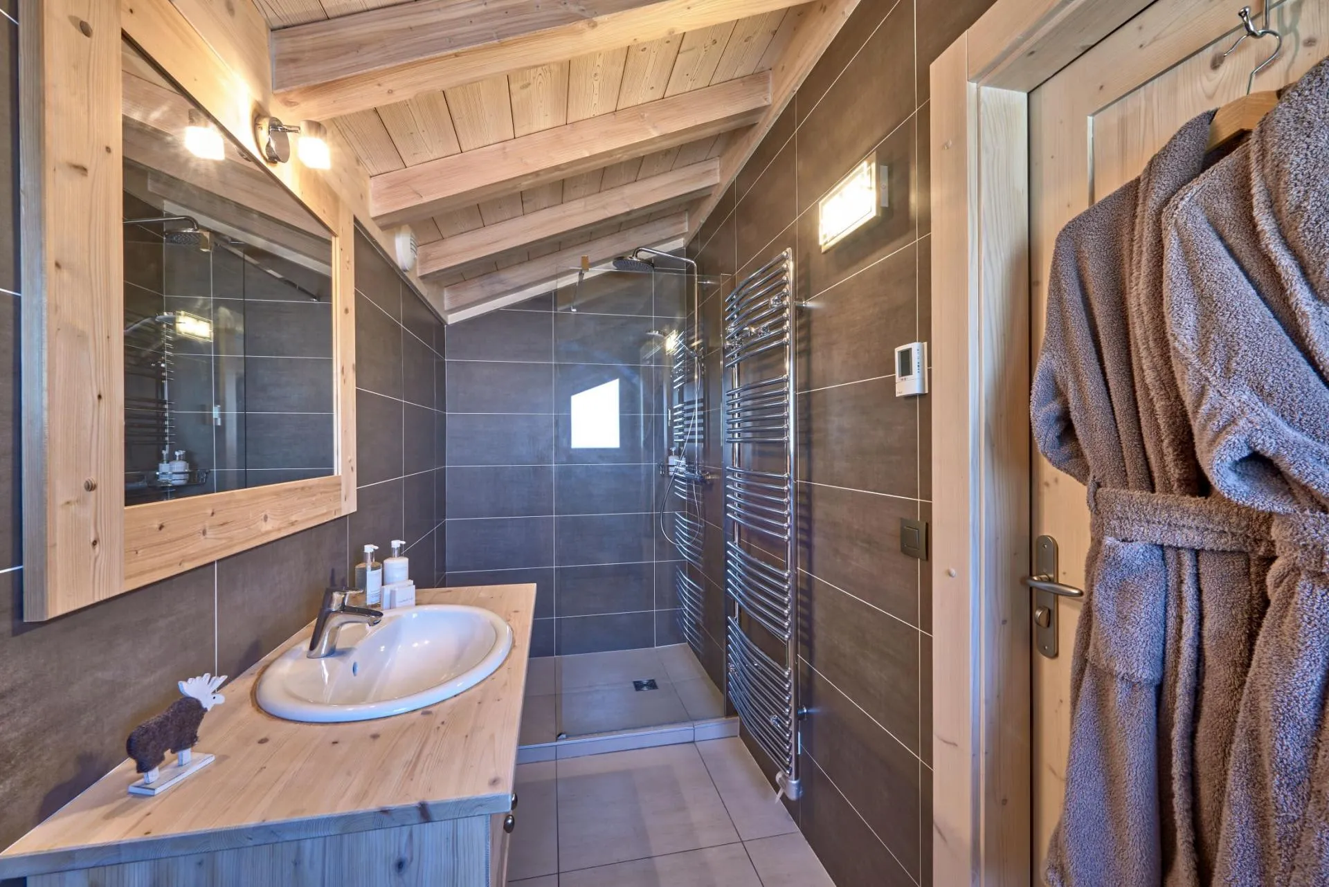 Bathroom with walk-in rainfall shower and heated towel rail
