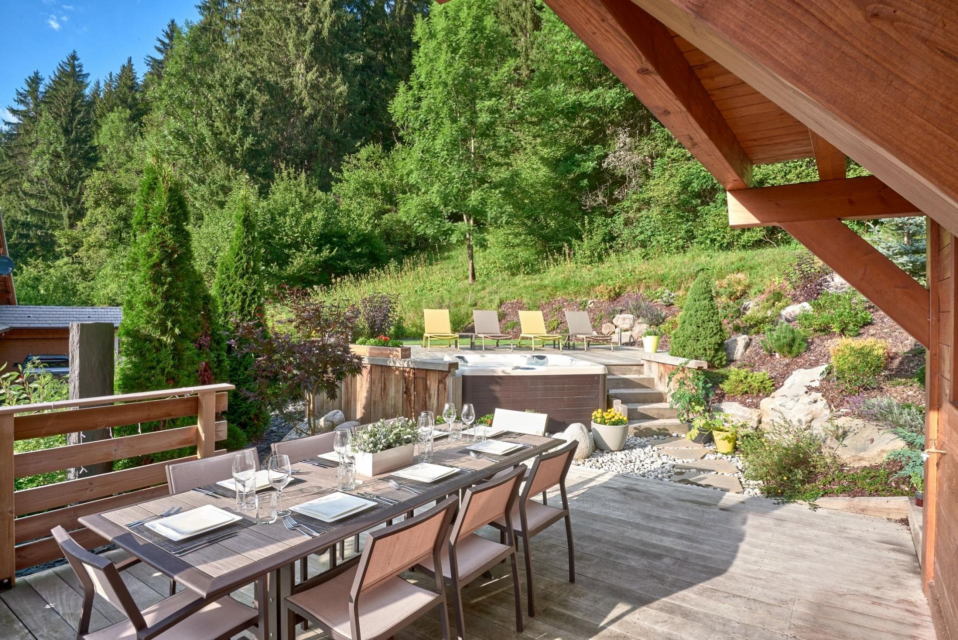 Deck with dining for 8, hot tub, and forest views