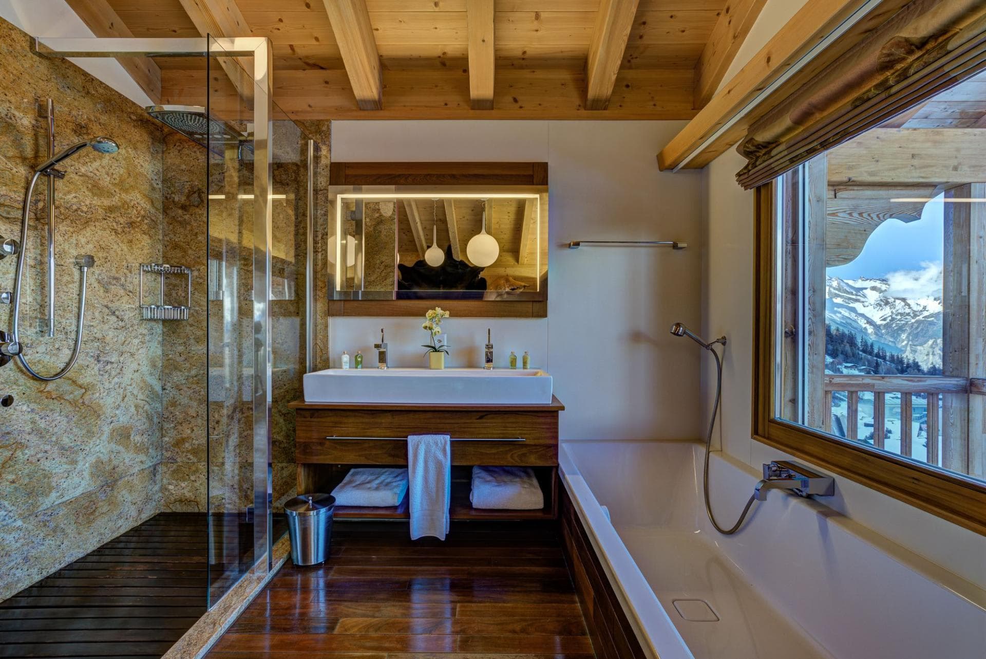 Bathroom with walk-in rainfall shower, soaking tub, and mountain views