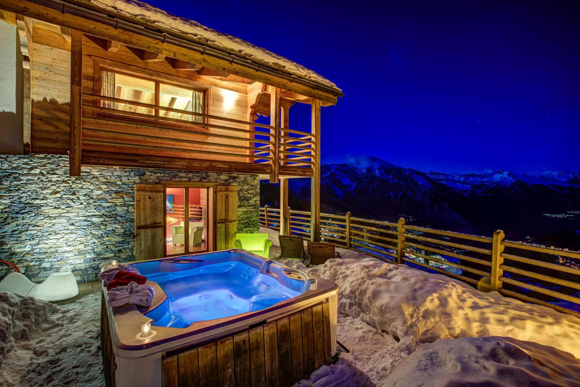 Outdoor hot tub with panoramic mountain views and chalet access