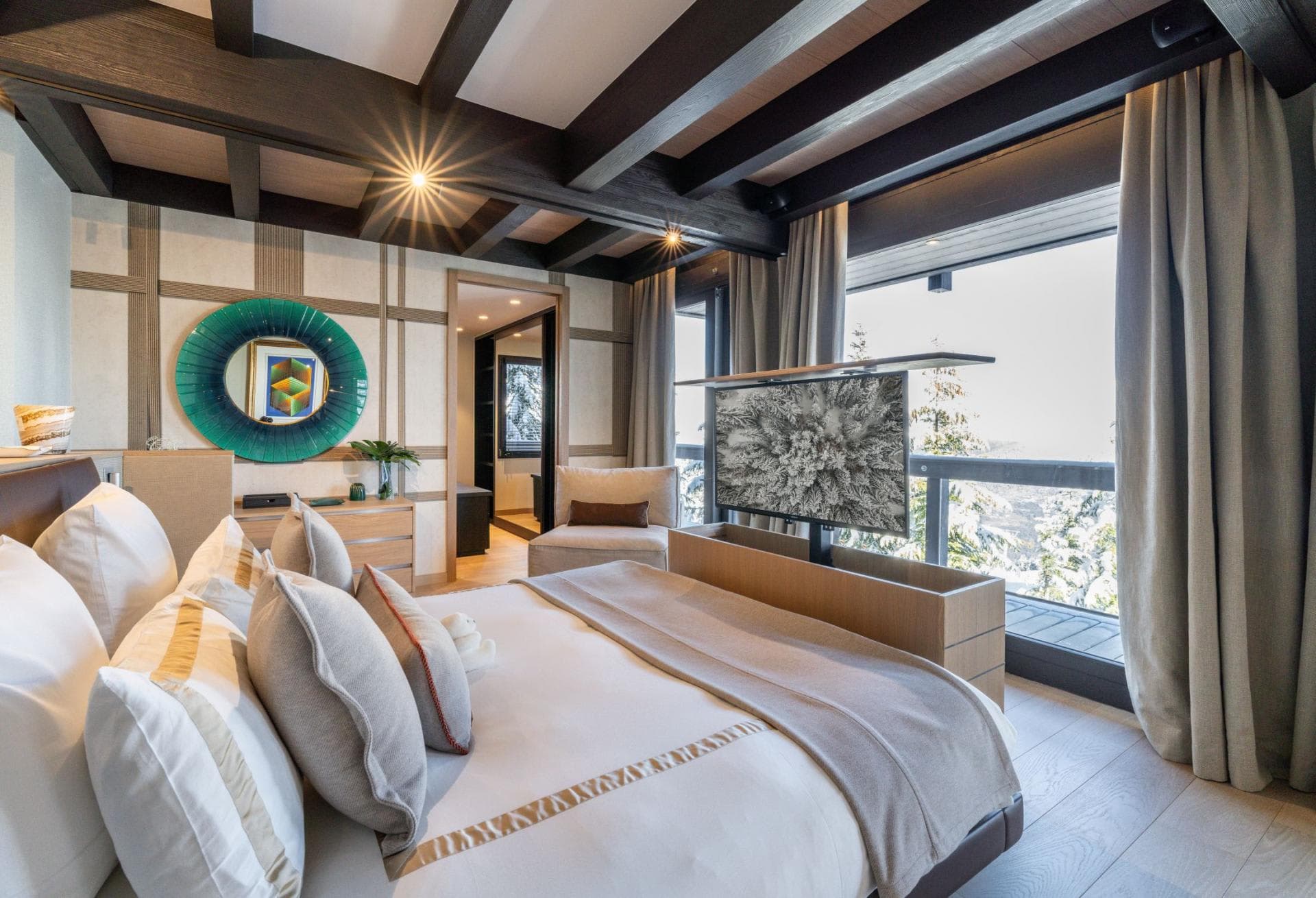 Primary bedroom with pop-up TV cabinet and private balcony access