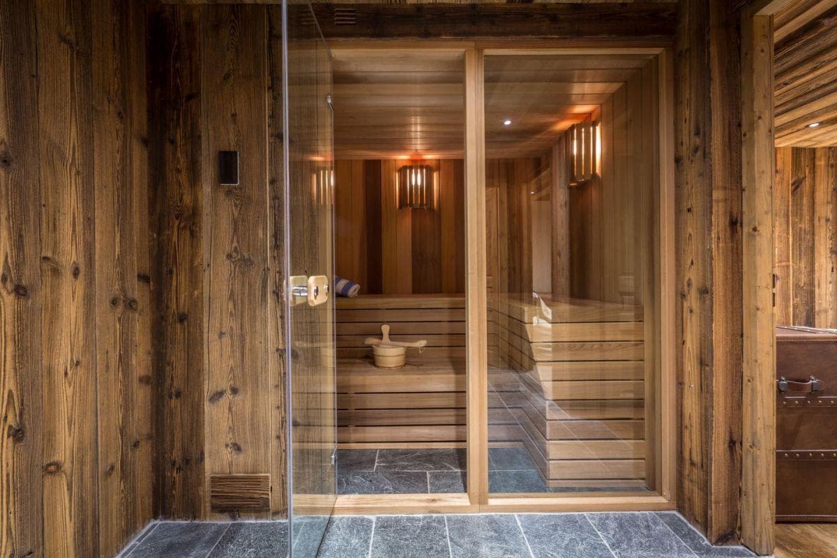 Private cedar sauna with tiered seating and glass door entrance