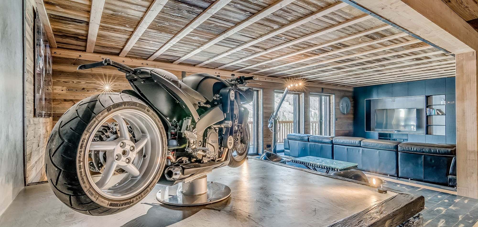 Media room featuring custom motorcycle display and sectional seating for 5