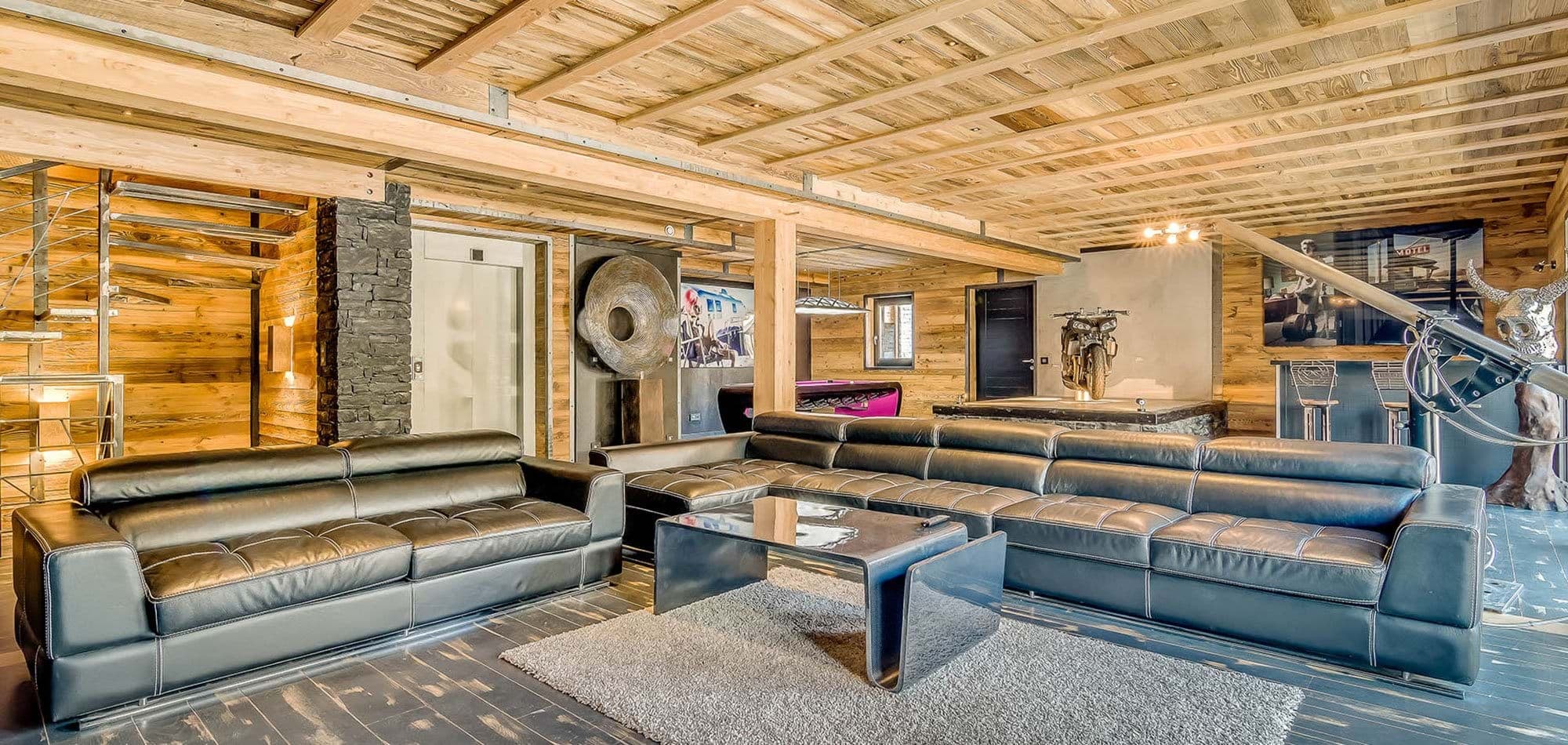 Lower level lounge with pool table, bar seating, and elevator access