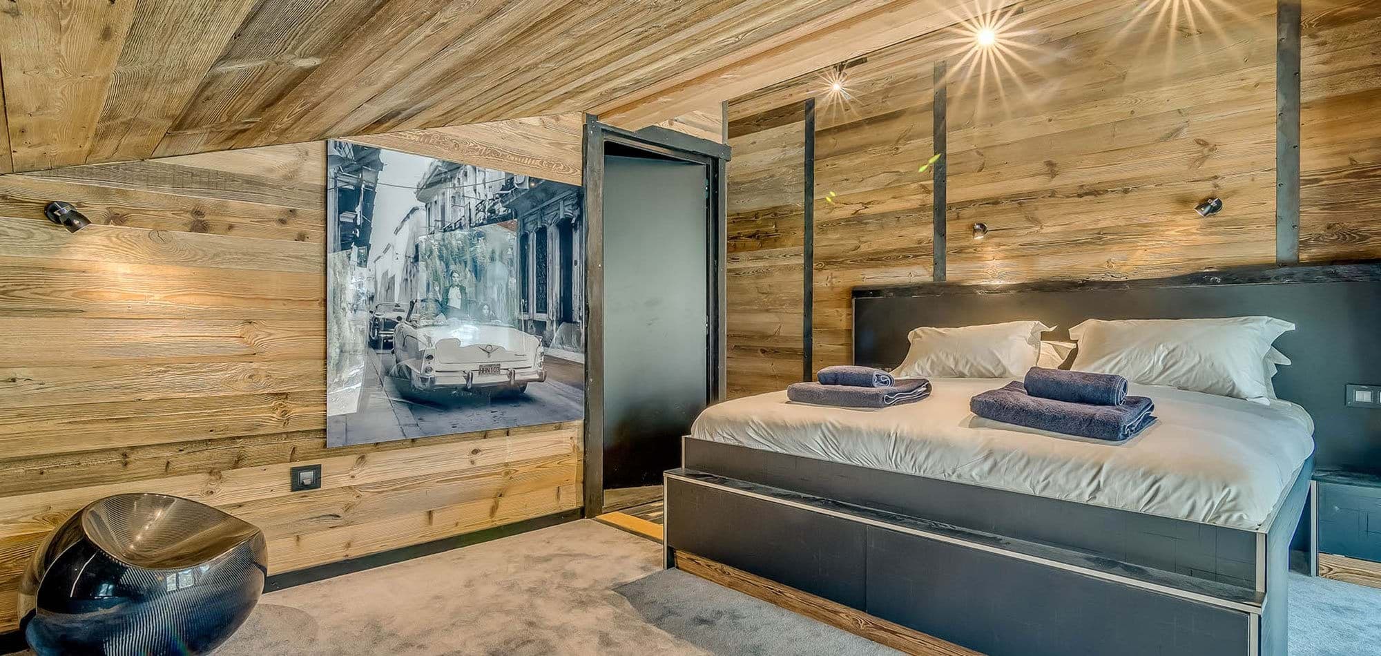 Loft bedroom with king bed and reclaimed wood paneling