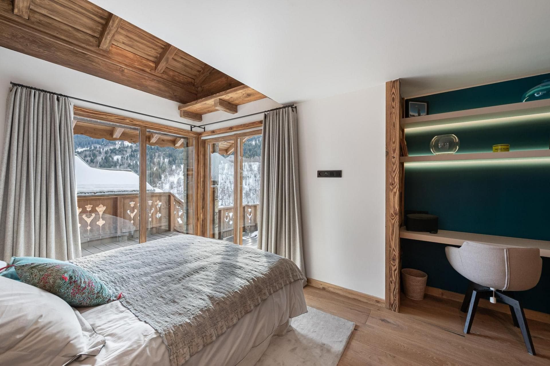 Bedroom with balcony access and integrated desk workspace