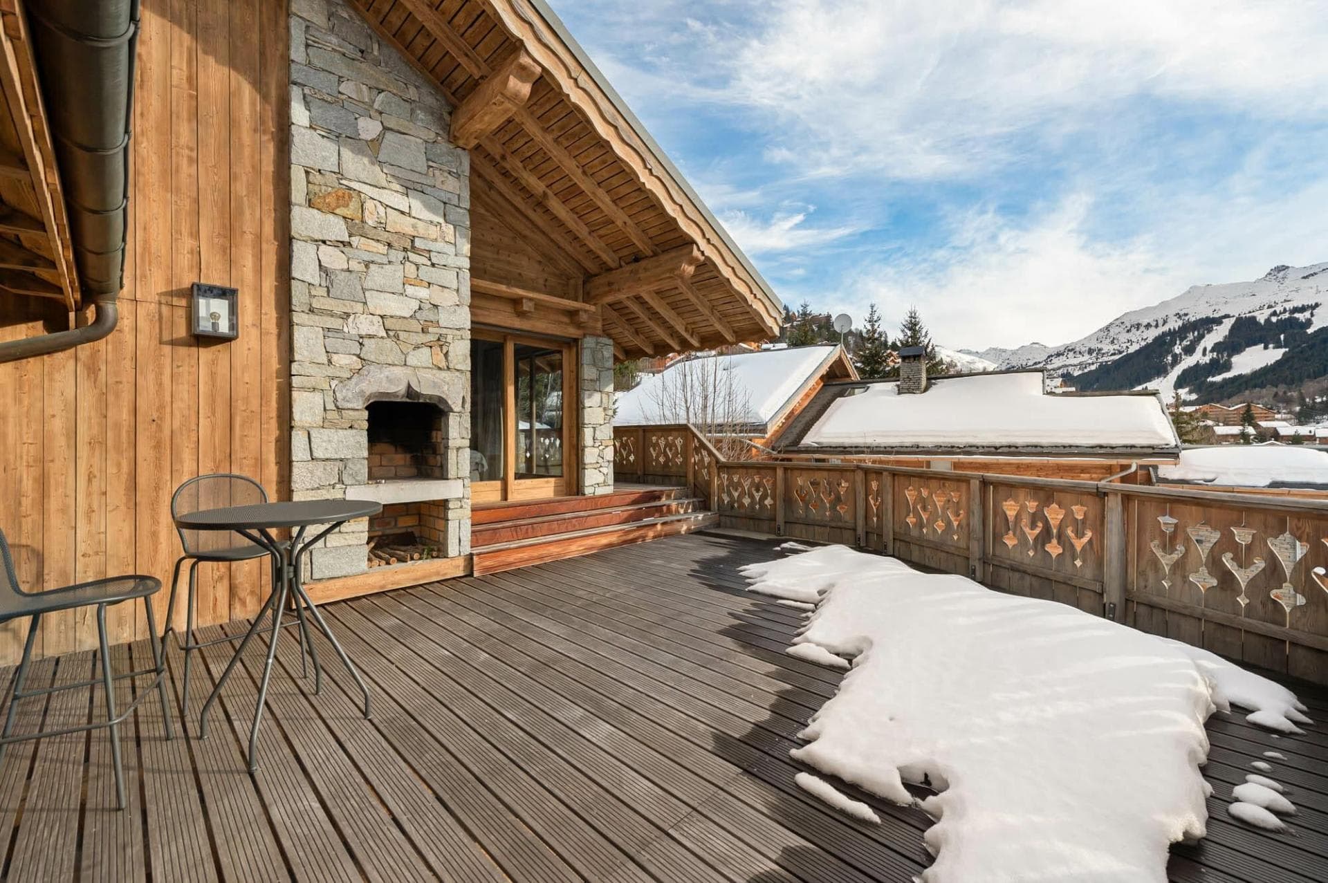 Private terrace with stone outdoor fireplace and mountain views
