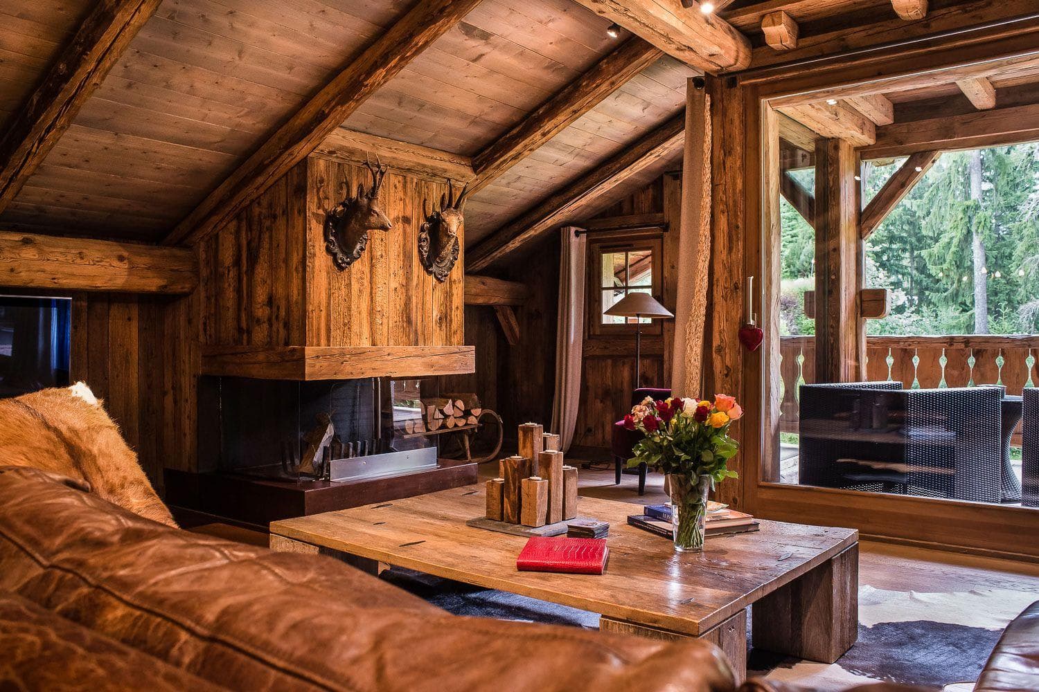 Living area with wood-burning fireplace and balcony access