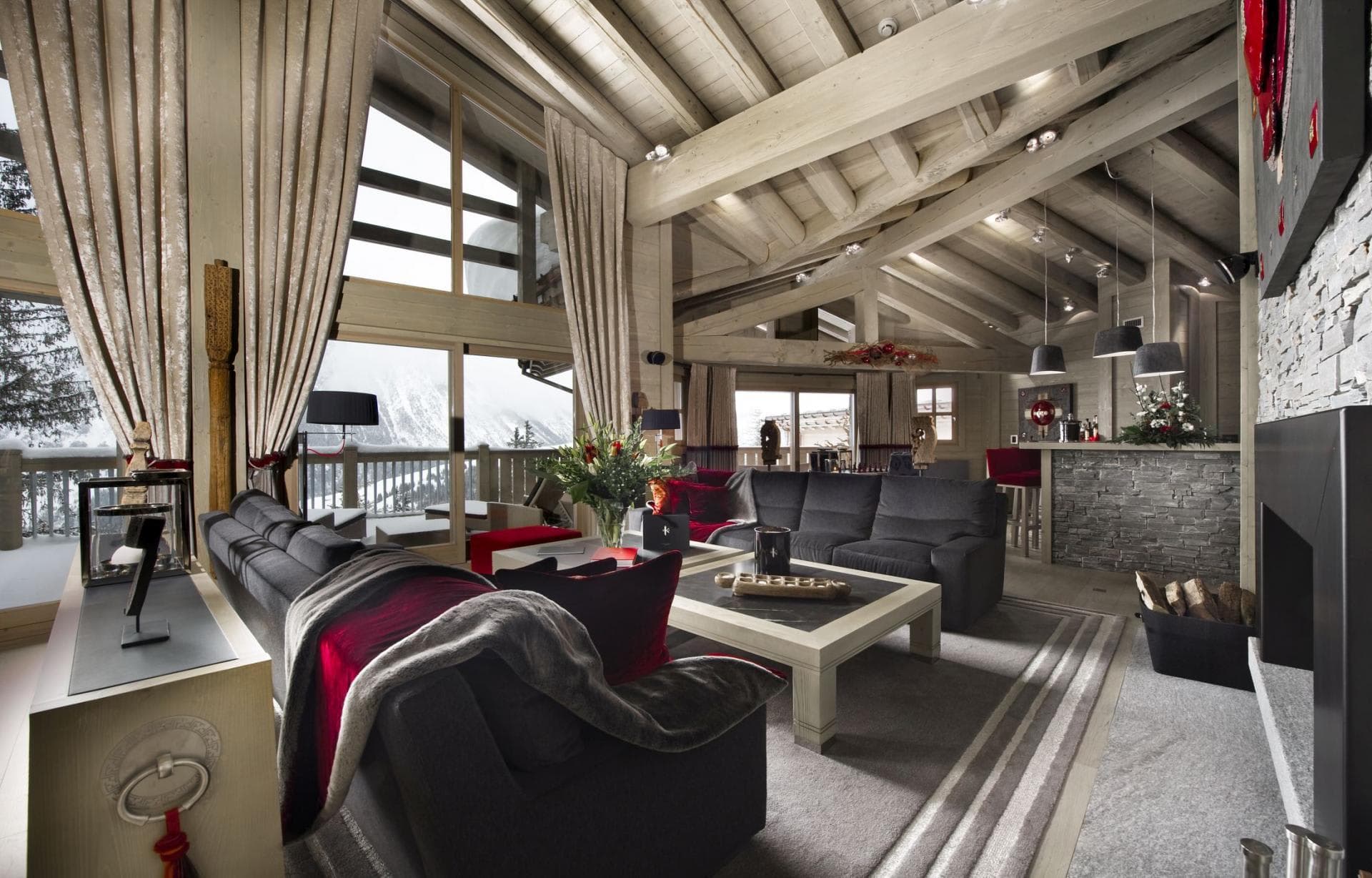 Living area with wood-burning fireplace, wet bar, and mountain-view balcony