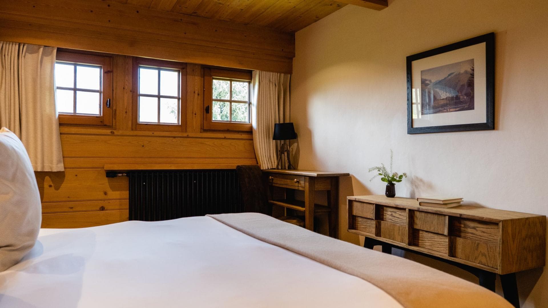 Wood-paneled bedroom with desk and dedicated workspace