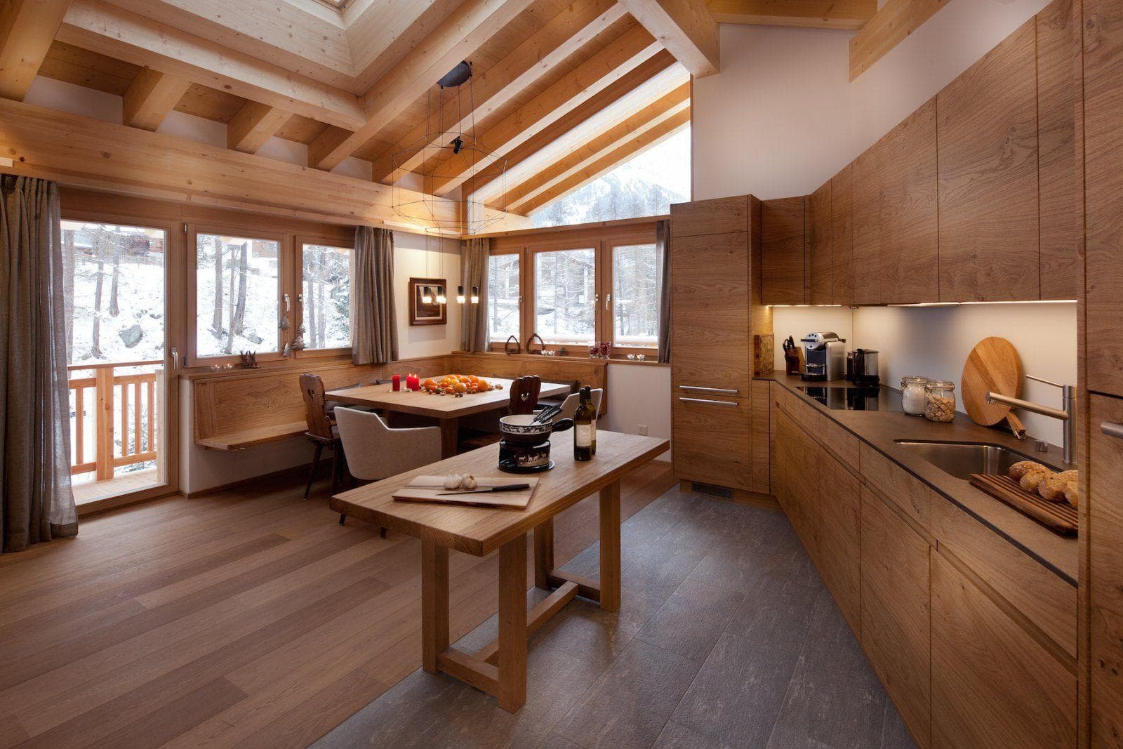Kitchen and dining nook with vaulted wood beams and mountain views