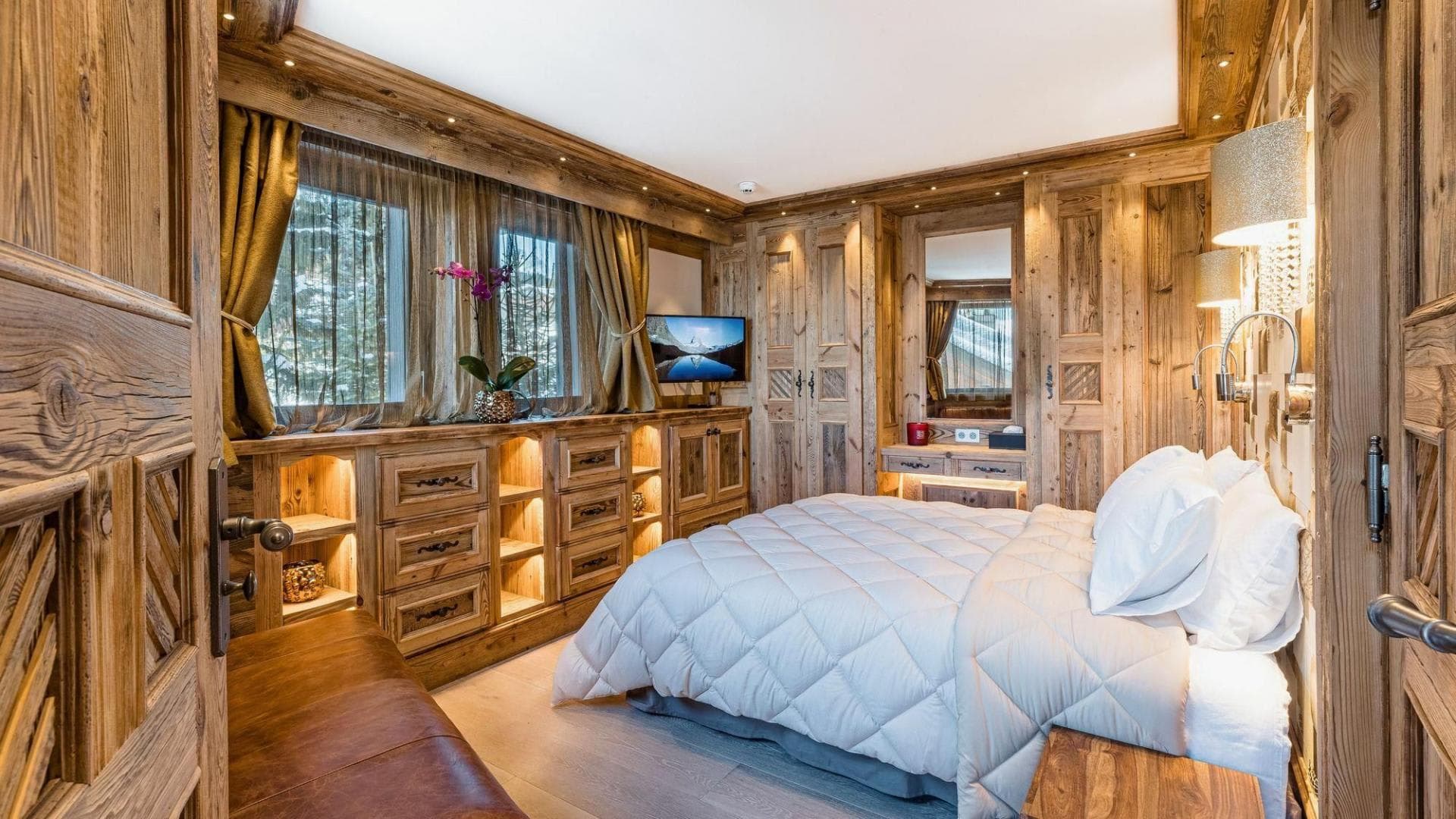 Guest bedroom with queen bed and built-in reclaimed wood storage and vanity
