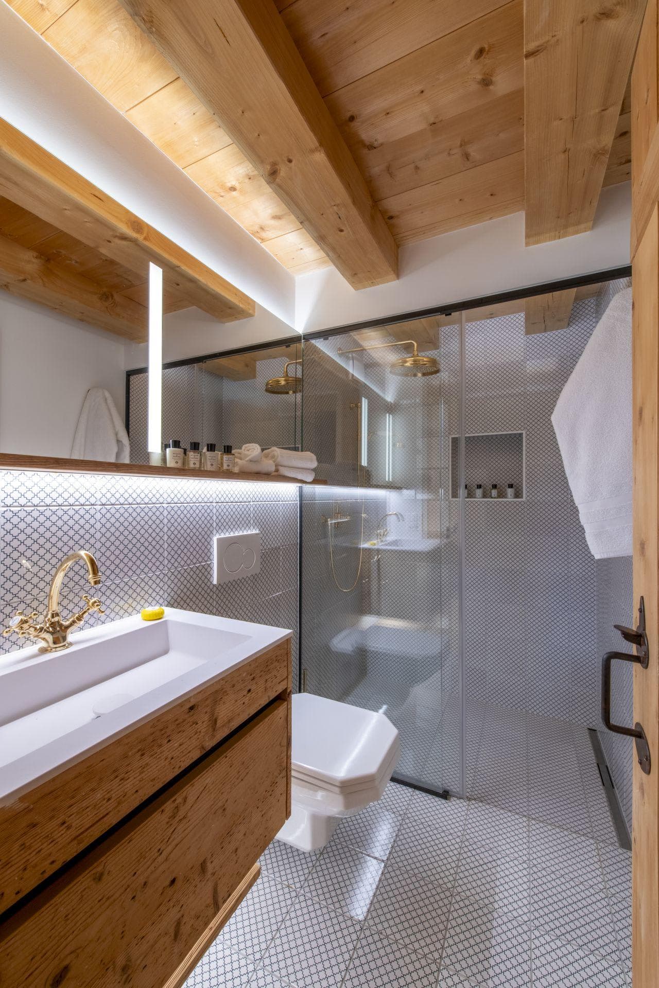 Bathroom with walk-in rainfall shower and exposed timber ceiling beams