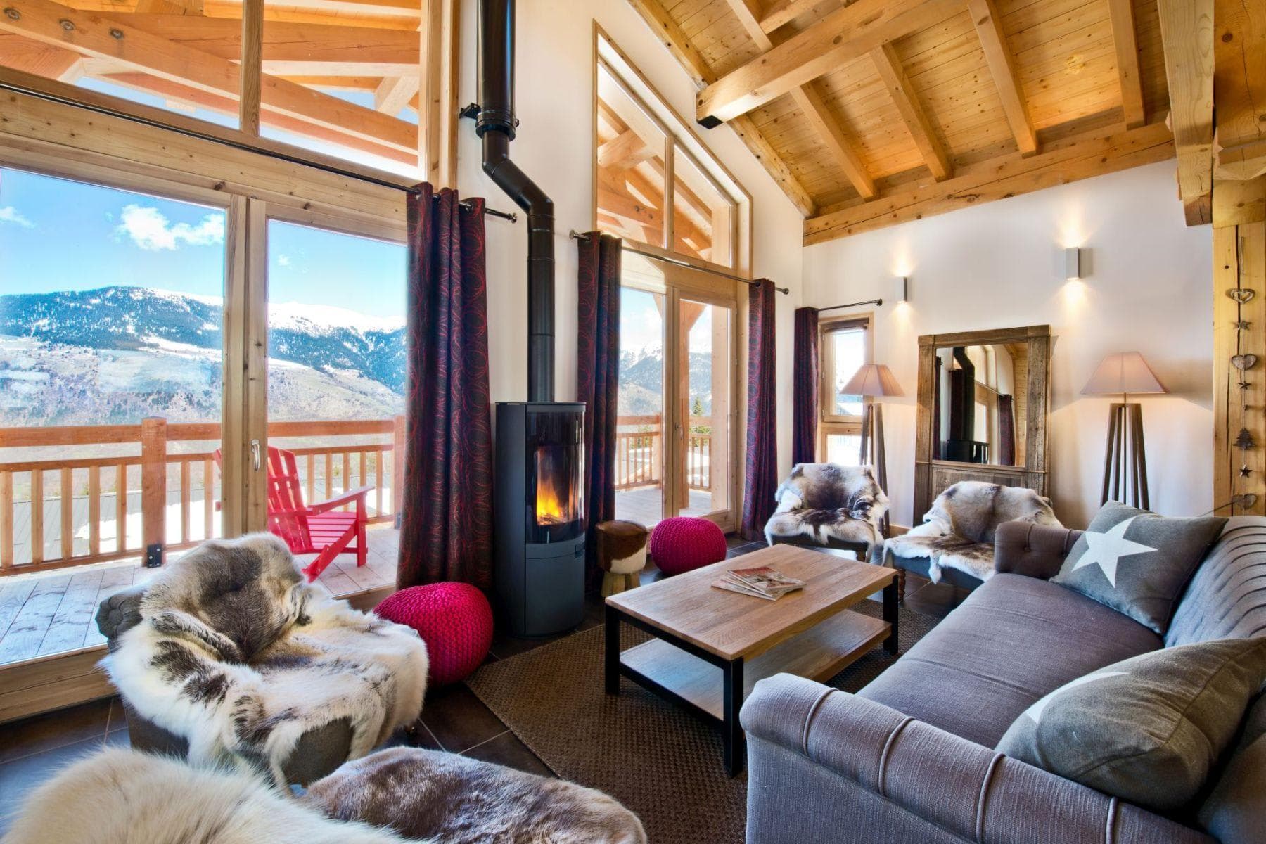 Living area with wood-burning stove and mountain views from private balcony