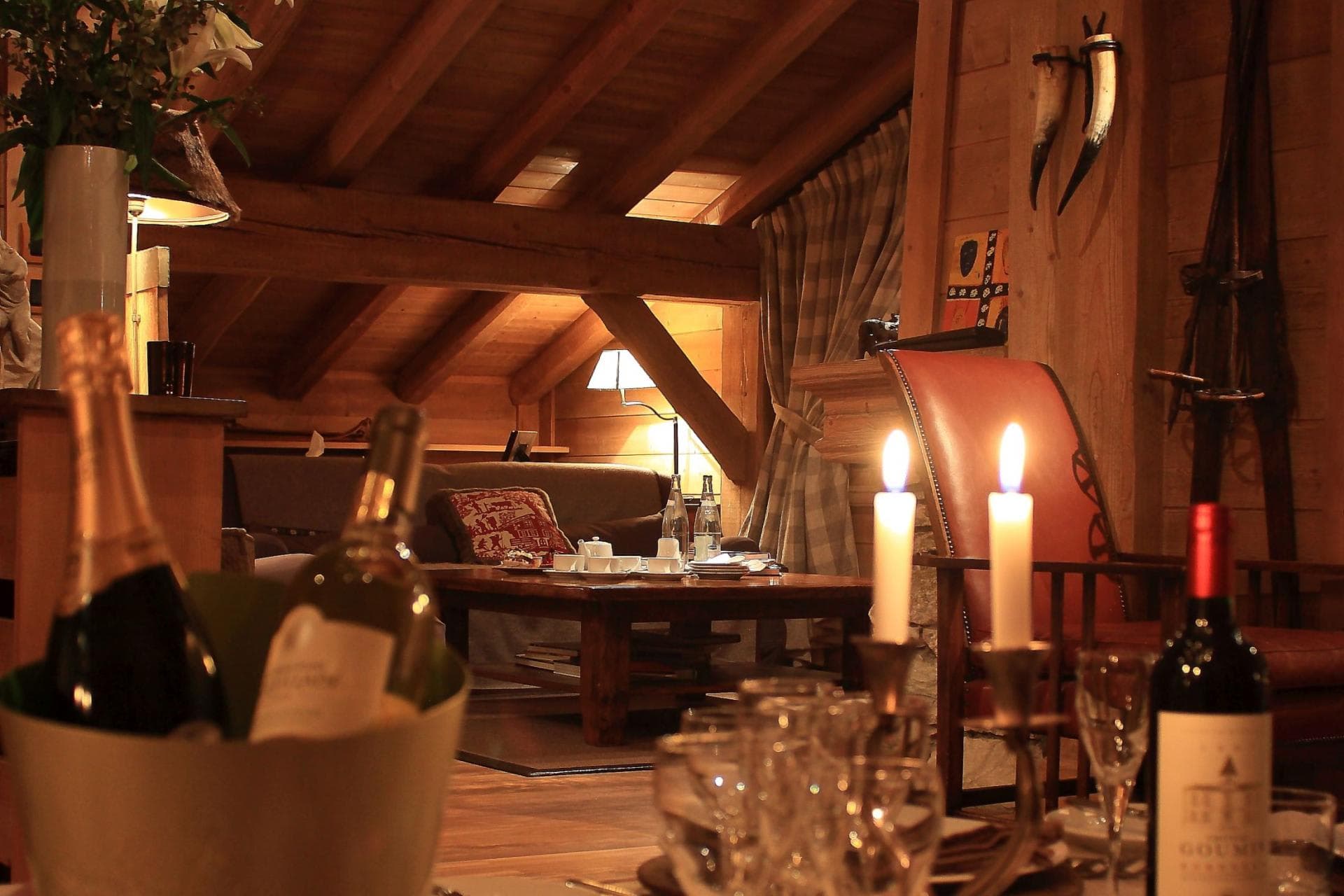 Upper-floor living area with vaulted timber beams and slanted ceilings